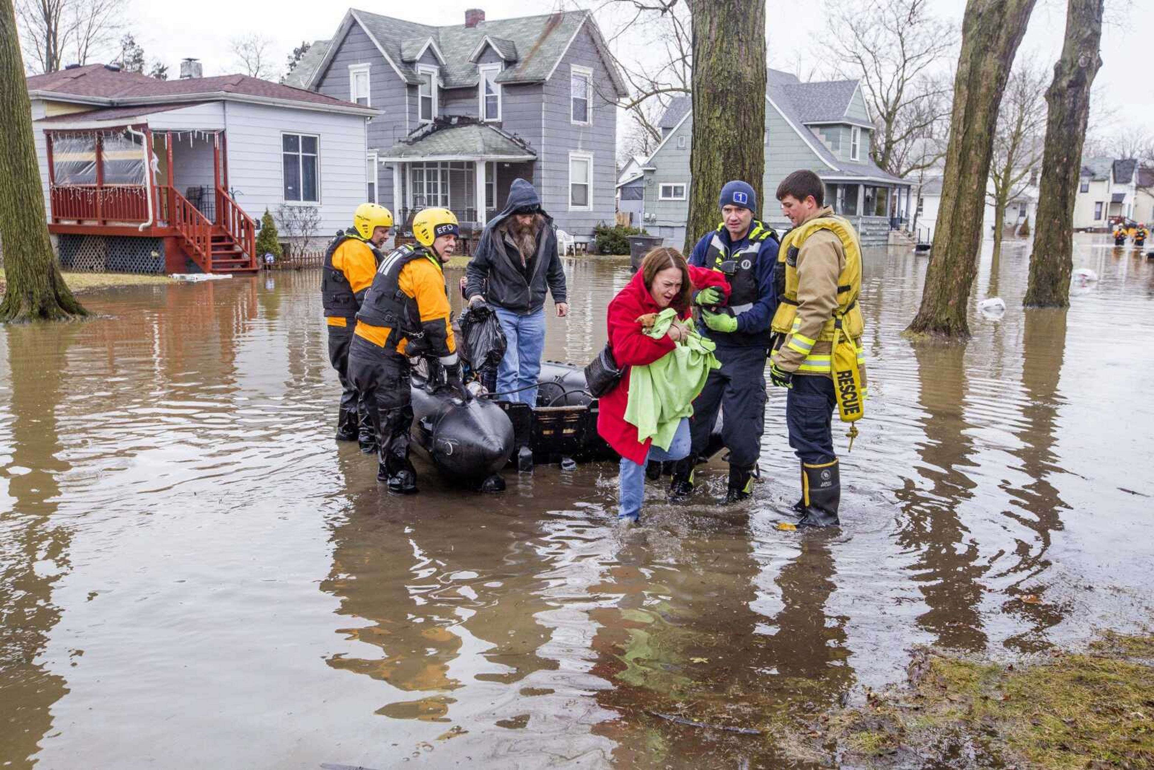 Emergency crews help evacuate residents Wednesday in Elkhart, Indiana. Crews are using boats to help northern Indiana residents amid flooding from melting snow and heavy rain moving across the Midwest.