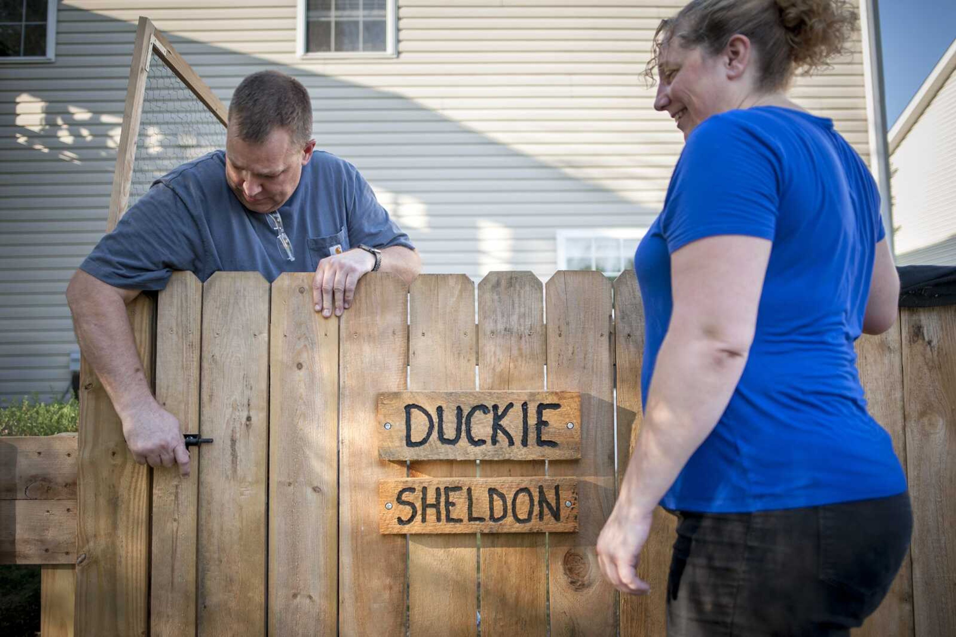 Tara Reeves watches her husband Dru lock the gate to a tortoise enclosure Sept. 12 at Reeves Reptile Rescue in Jackson.