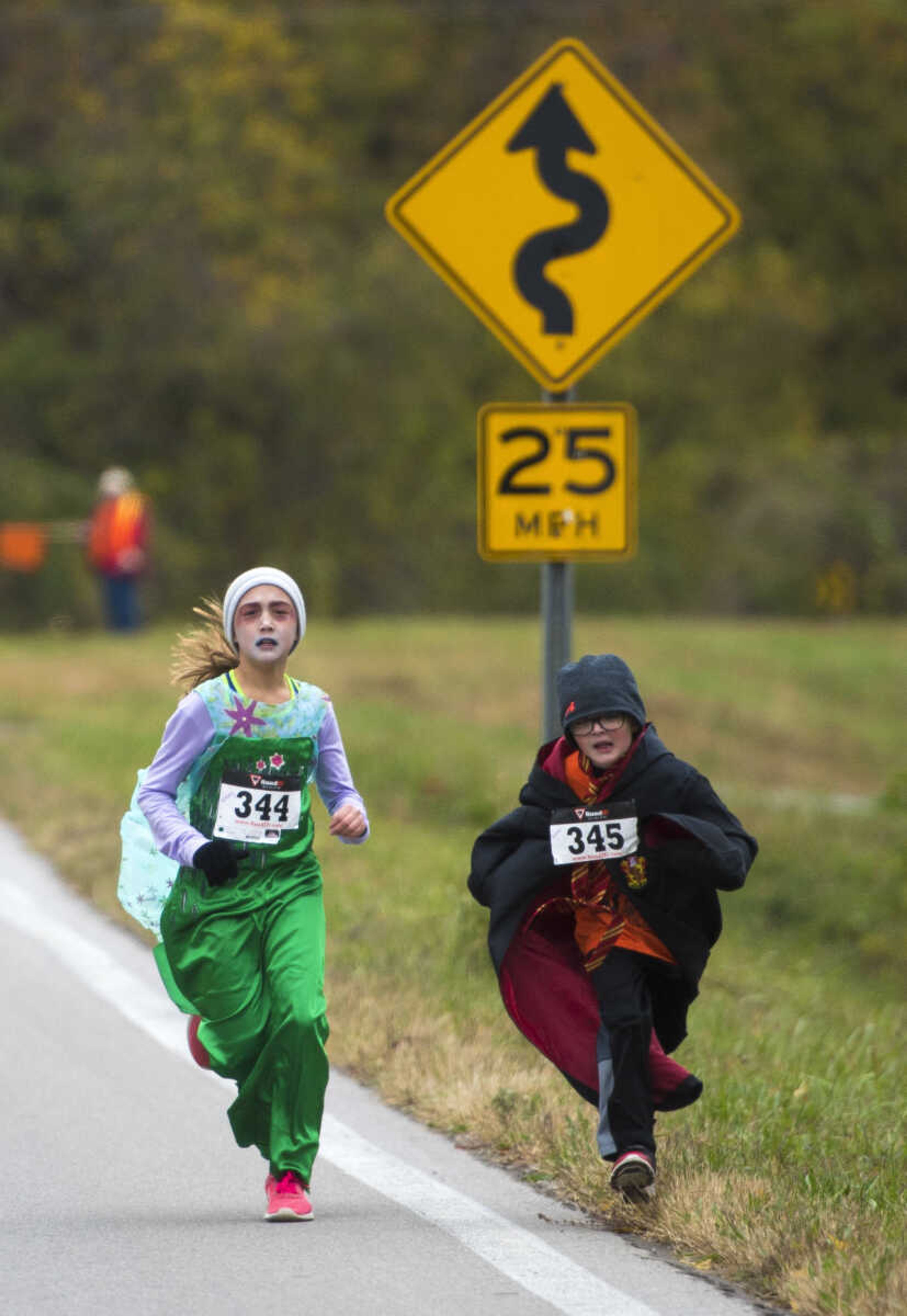 Whitney Goodwin, 9, left, and her cousin Tristan Vines, 7, run during the first Ghost and Goblin Gallop 5k race to raise money for the Crossroads Backpack Fair on Saturday, Oct. 28, 2017 in Jackson.