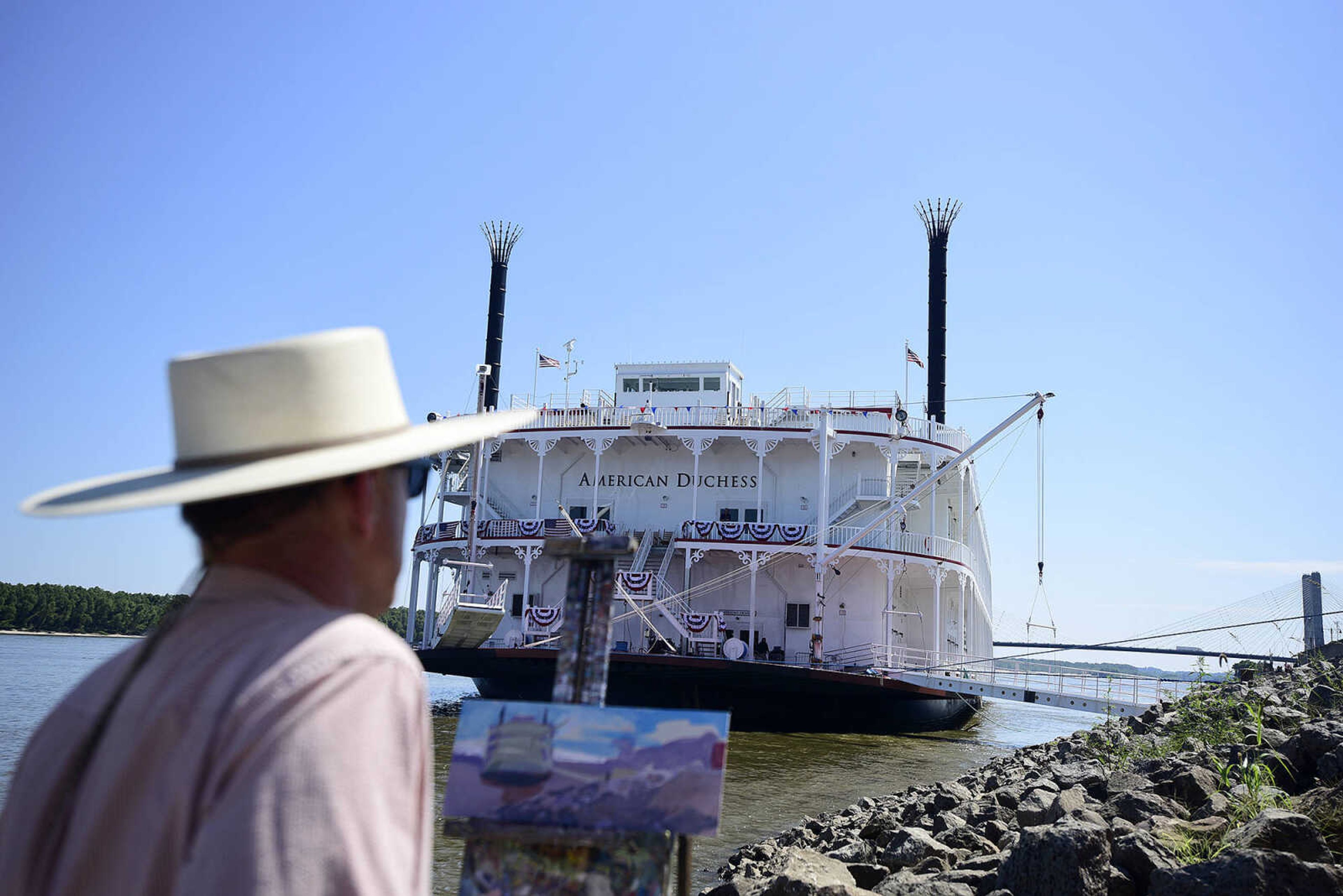 Craig Thomas paints the American Duchess riverboat during its stop at Riverfront Park in downtown Cape Girardeau on Saturday, Aug. 26, 2017.