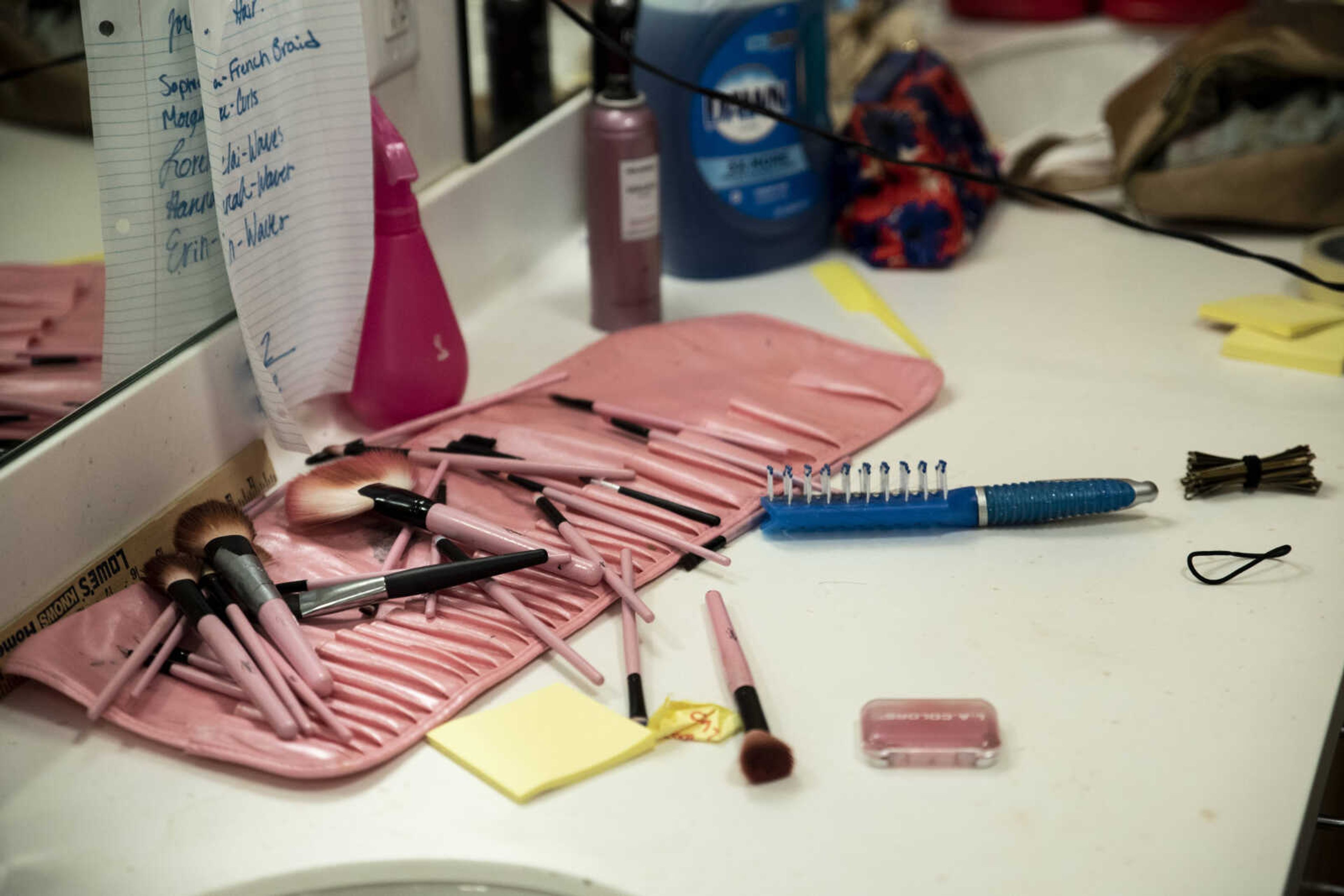 Makeup brushes rest on the counter backstage during the media night of Cape Central High School's spring musical production of "Mamma Mia!" Wednesday, April 10, 2019, in Cape Girardeau.