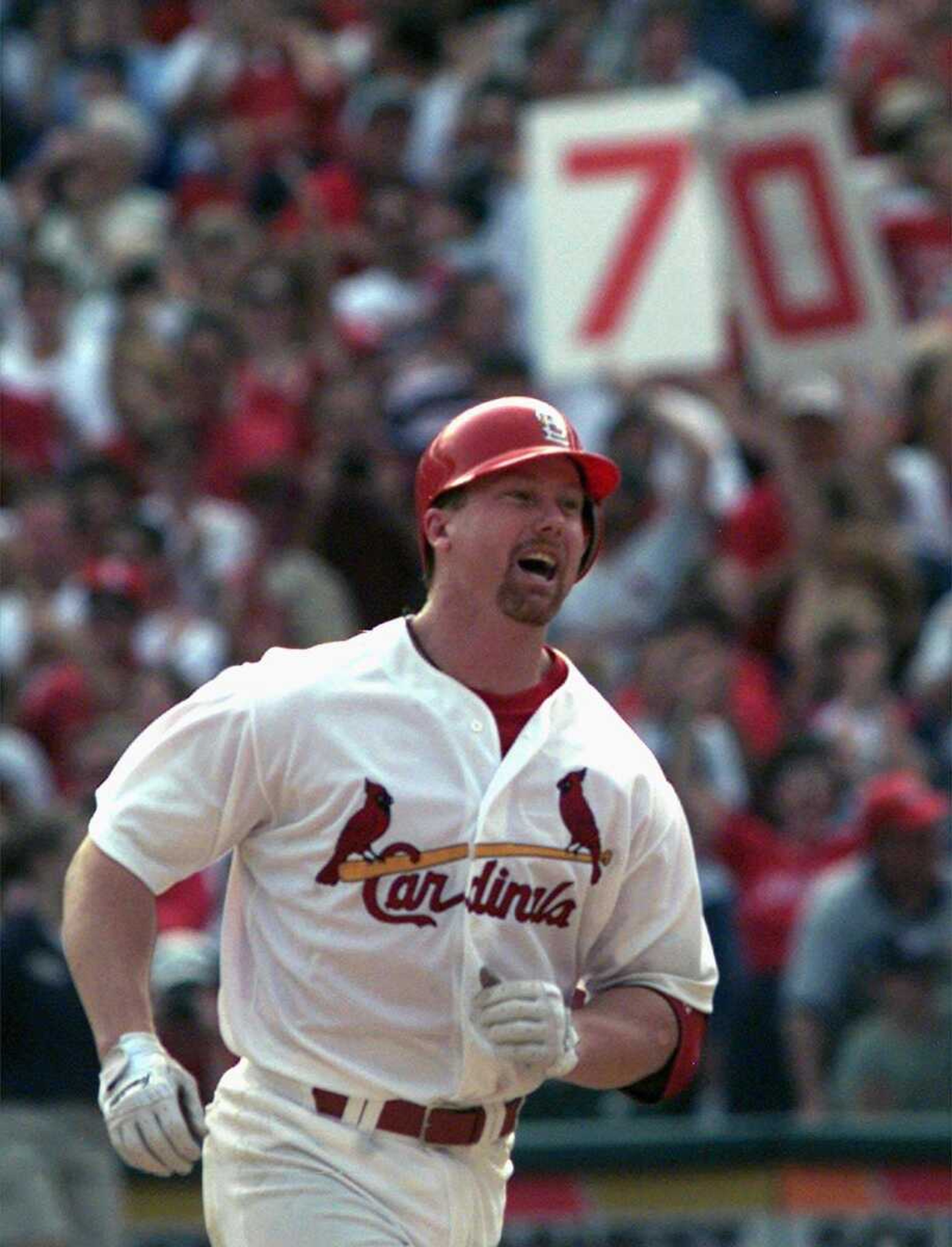 Associated Press file<br>Mark McGwire hits his 70th home run in 1998.