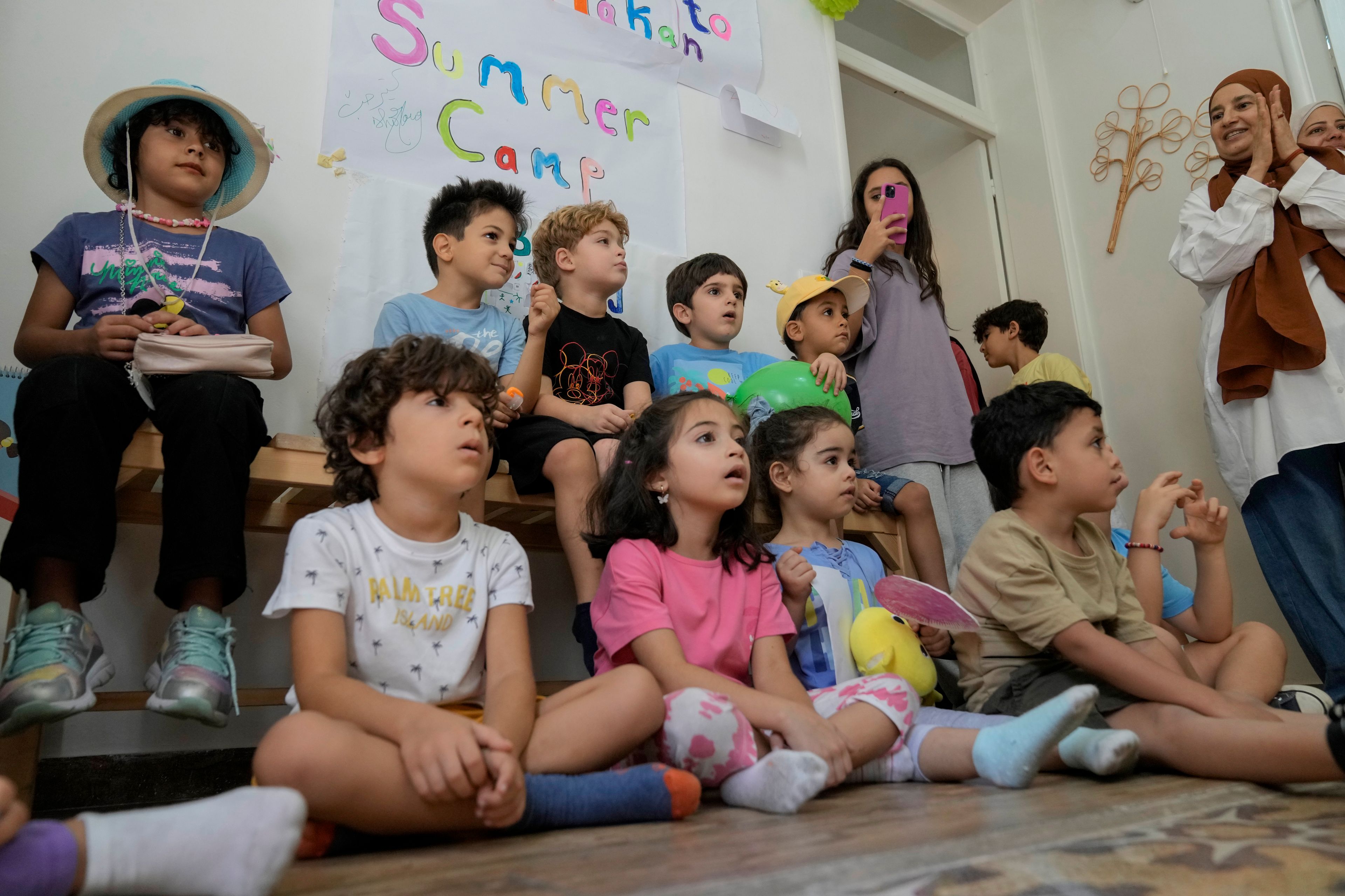 Palestinian children who were brought to Lebanon from the Gaza Strip for treatment, join Lebanese children at a summer camp in Beirut, Lebanon, Friday, Aug. 30, 2024. (AP Photo/Bilal Hussein)