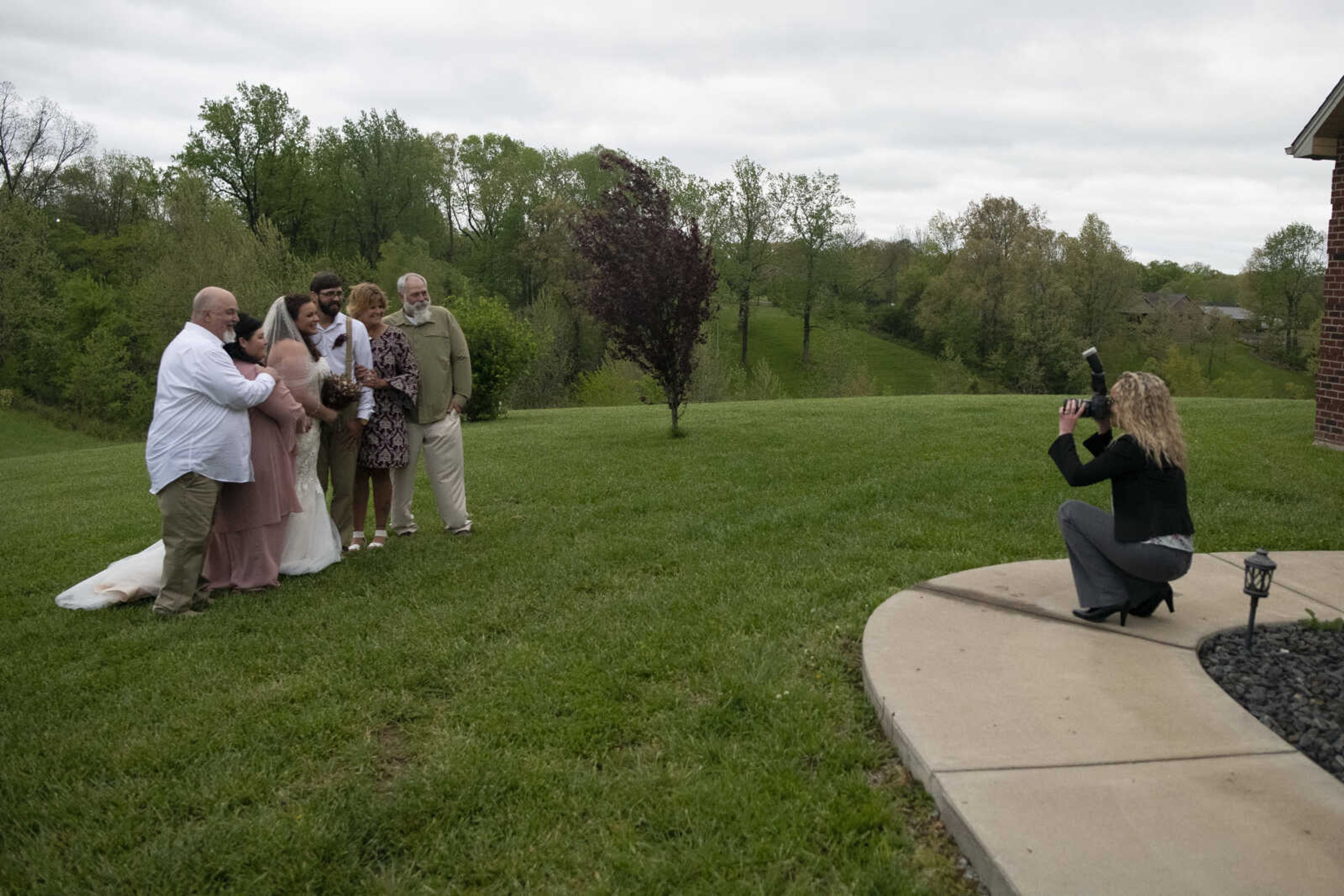 Jenni (Heisserer) Kroenung and Trevor Kroenung have wedding pictures taken by photographer Crockette McColl with Jenni's parent's John and Angel Heisserer (left pair) and Trevor's parents Belinda Bollinger and Phil Kroenung (right pair) on Saturday, April 25, 2020, in Scott County, Missouri.