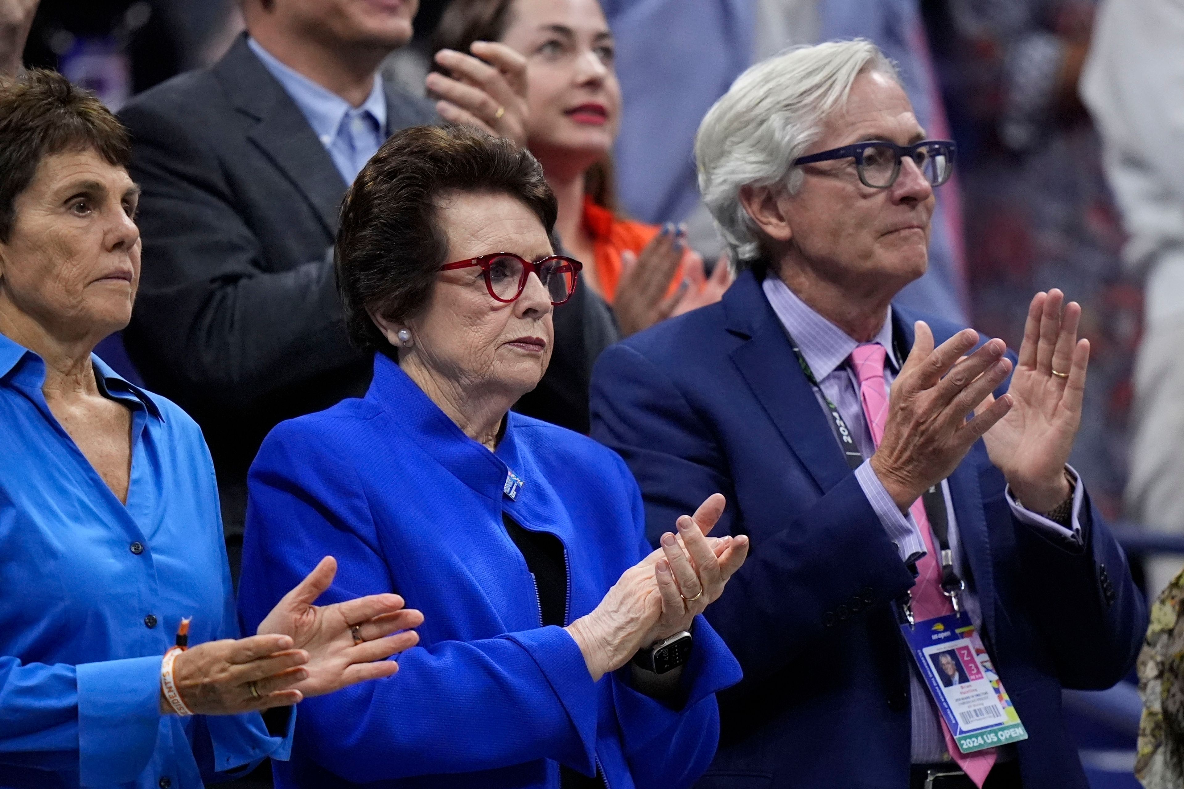 Billie Jean King, center, her wife Ilana Kloss and USTA president Brian Hainline, arrives for the women's singles final of the U.S. Open tennis championships between Aryna Sabalenka, of Belarus, and Jessica Pegula, of the United States, Saturday, Sept. 7, 2024, in New York. (AP Photo/Frank Franklin II)