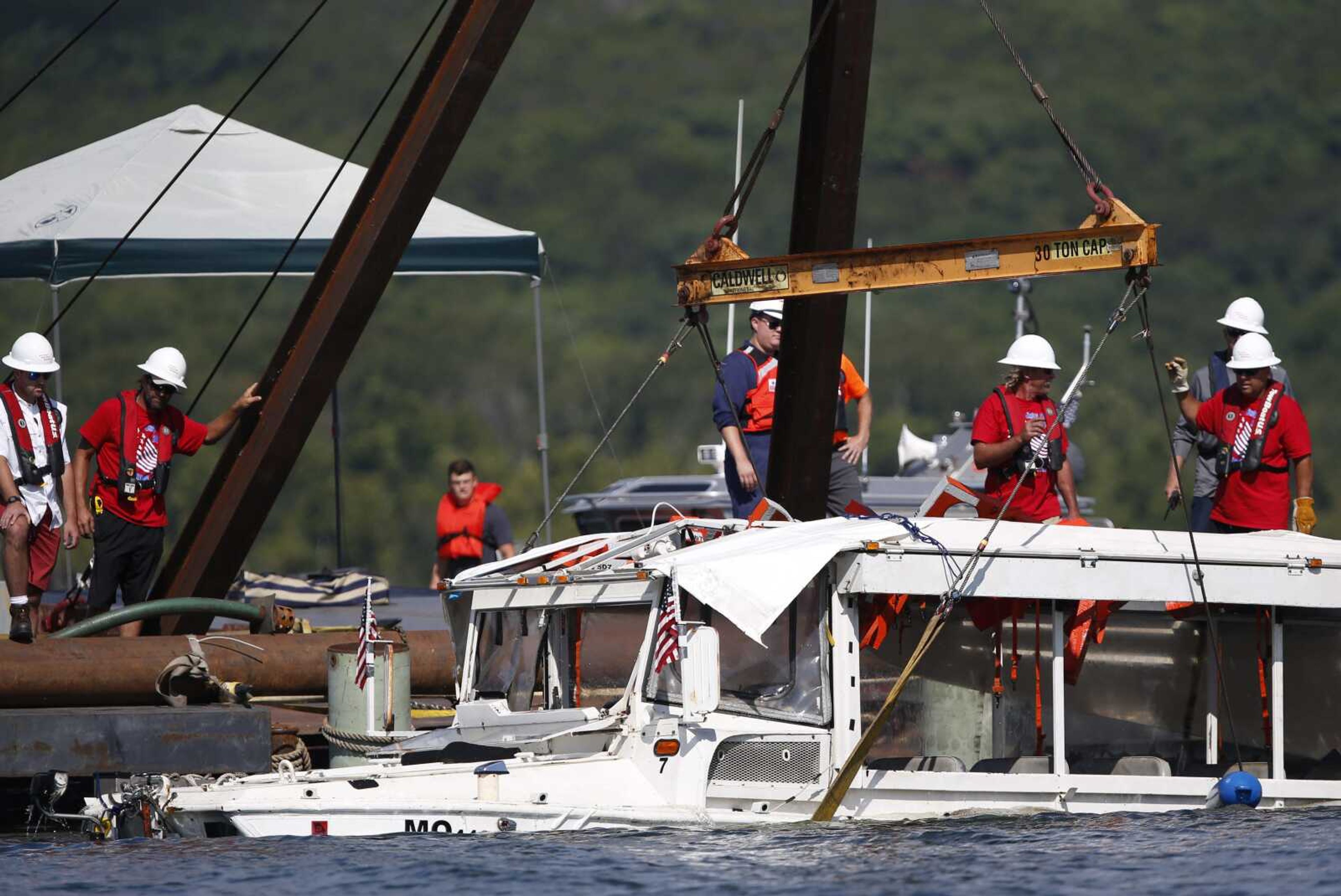 A duck boat that sank in Table Rock Lake in Branson, Missouri, is raised July 23, 2018, after it went down the evening of July 19 after a thunderstorm generated near-hurricane strength winds.