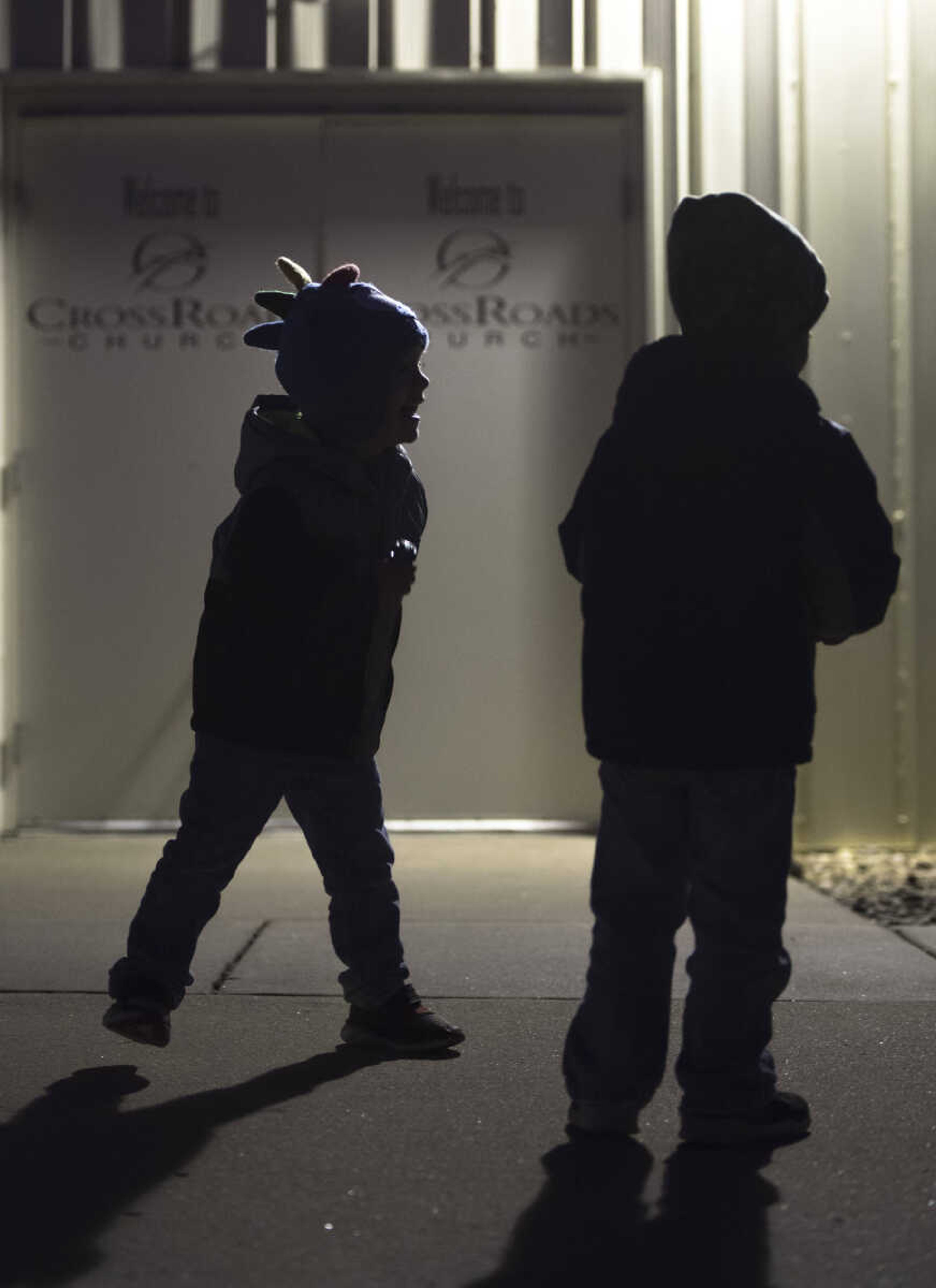 Three-year old Sikeston twins Sam, left, and Jude Popst play on a sidewalk outside of Crossroads Church during a community worship event Sunday evening, Oct. 13, 2019, in Jackson.