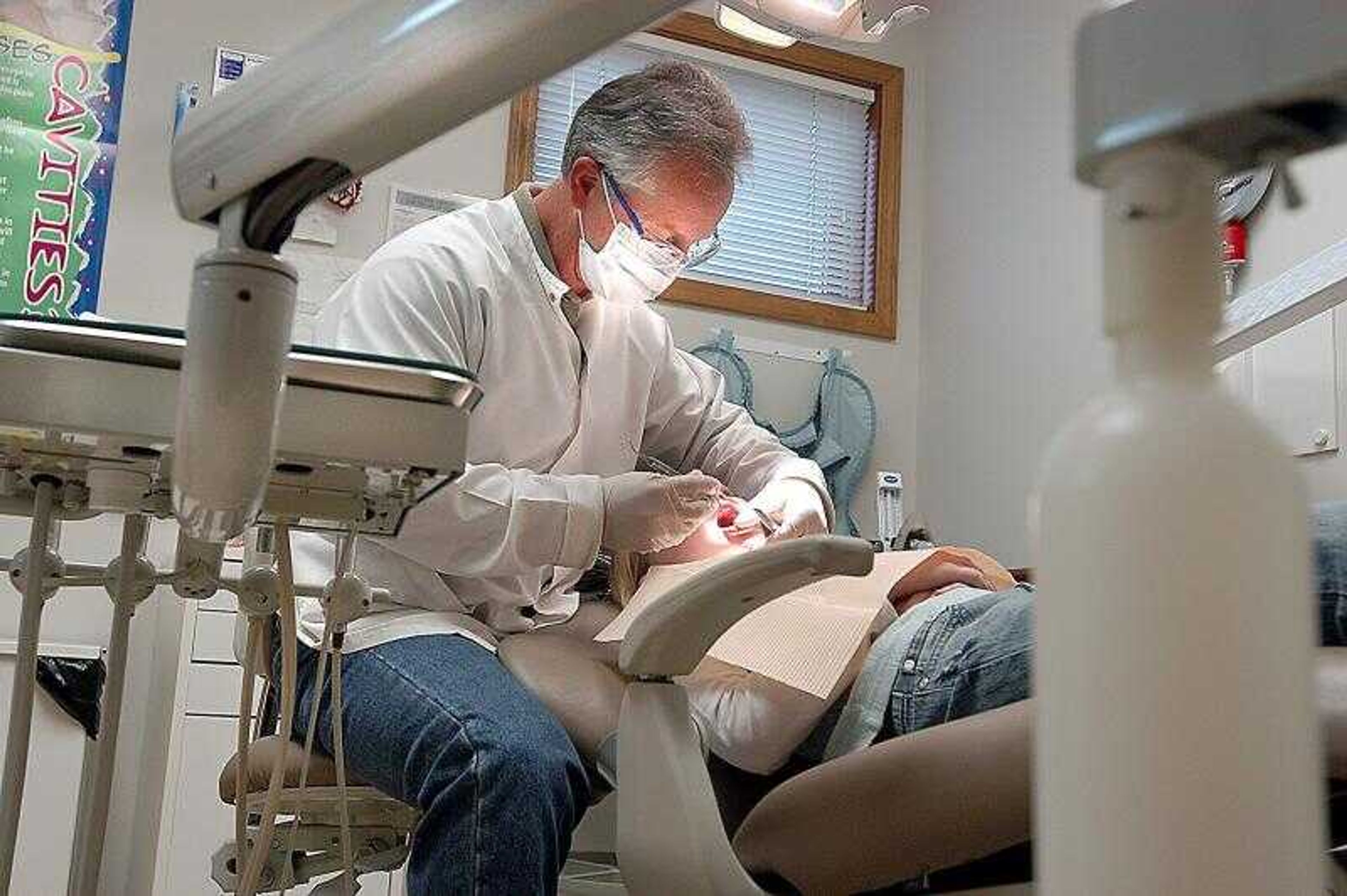 Dental hygienist Joe Cravens cleaned 10-year-old Bettie Jo Kibrough's teeth Friday at Cross Trails Medical Center in Marble Hill, Mo. (Diane L. Wilson)