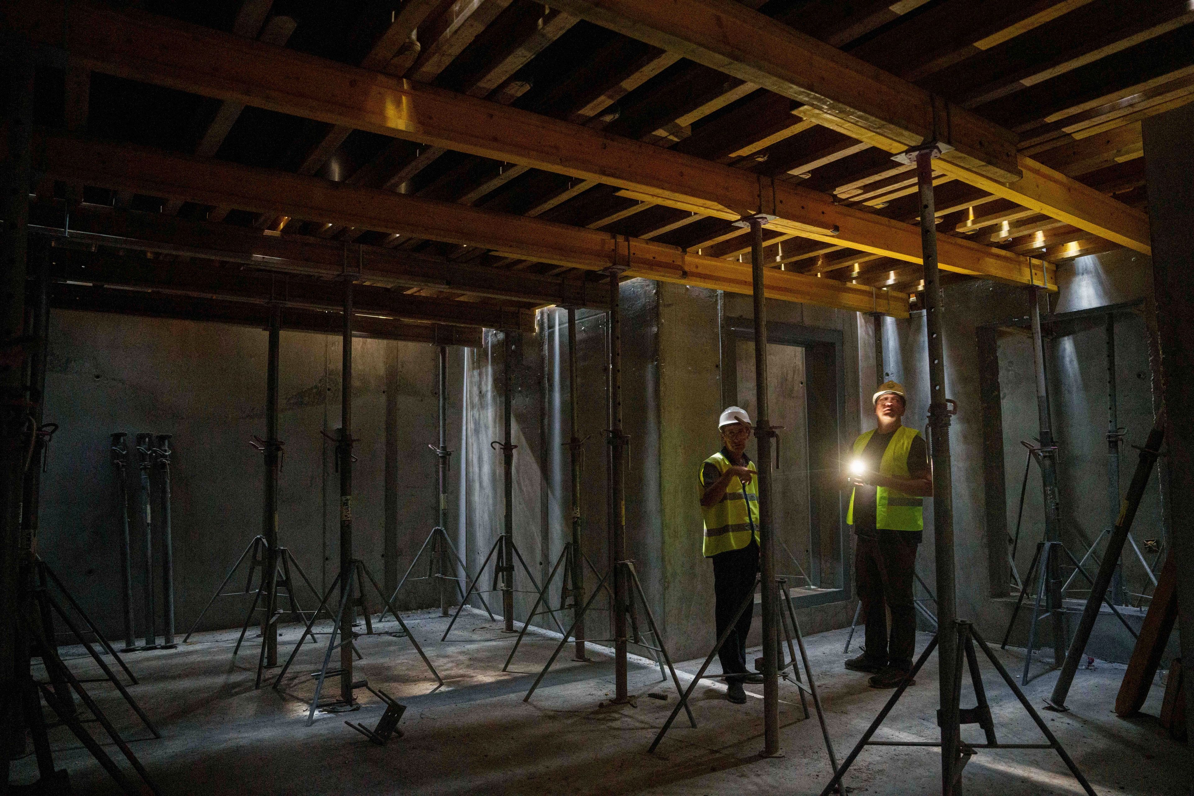 Builders inspect the construction of an underground version of School No. 88 in Zaporizhzhia, Ukraine, Aug. 30, 2024. (AP Photo/Evgeniy Maloletka)