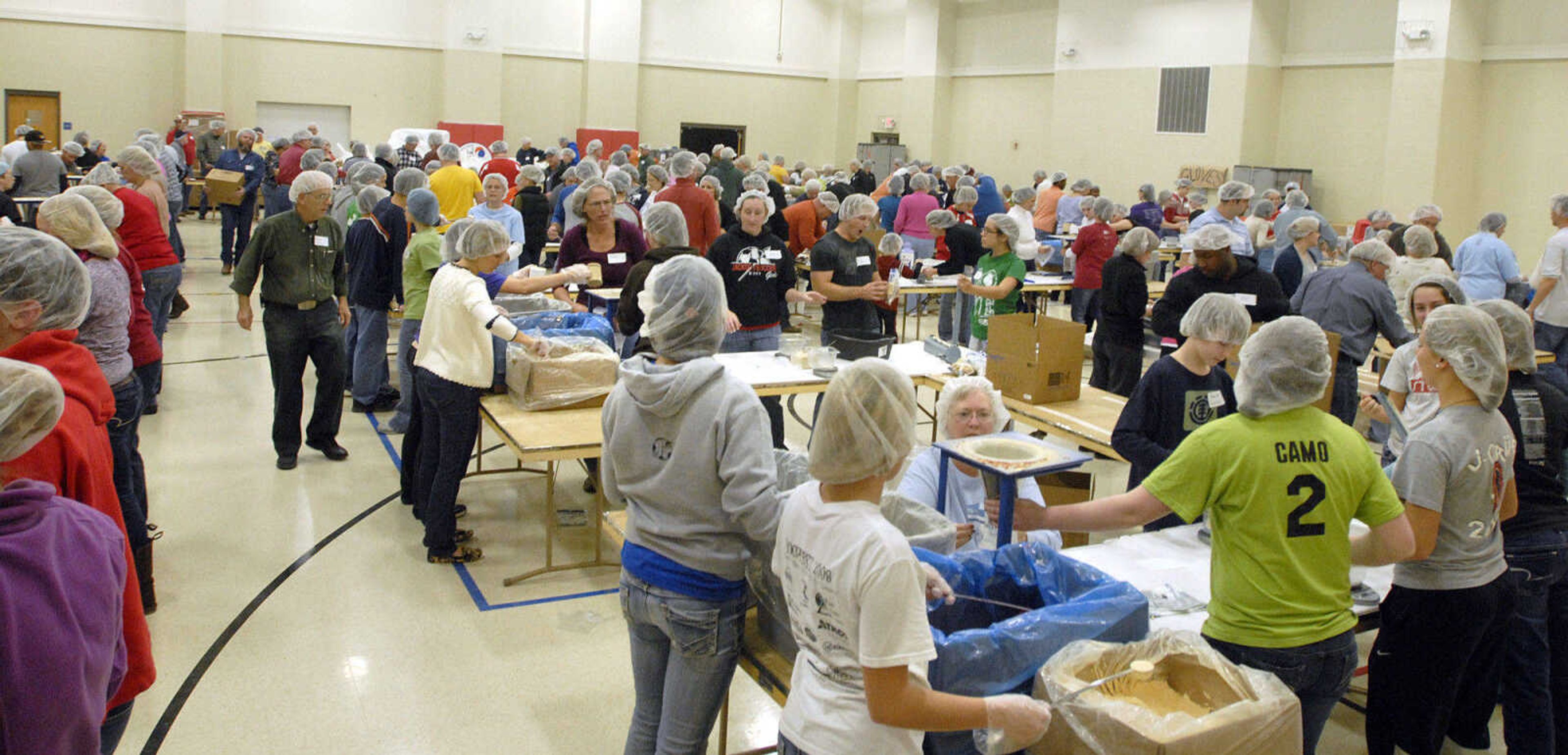 LAURA SIMON ~ lsimon@semissourian.com
Over 200 volunteers fill the Shawnee Park Center Friday night, Dec. 9, 2011 during the Feed My Starving Children Mobilepack event in Cape Girardeau.