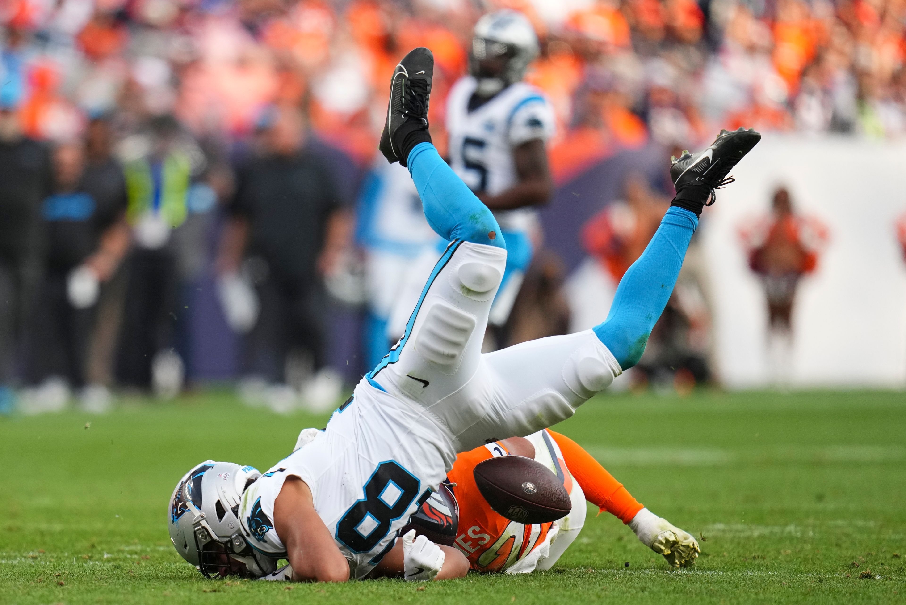 Denver Broncos safety Brandon Jones (22) tackles Carolina Panthers wide receiver Jalen Coker (18) during the second half of an NFL football game Sunday, Oct. 27, 2024, in Denver. (AP Photo/Jack Dempsey)