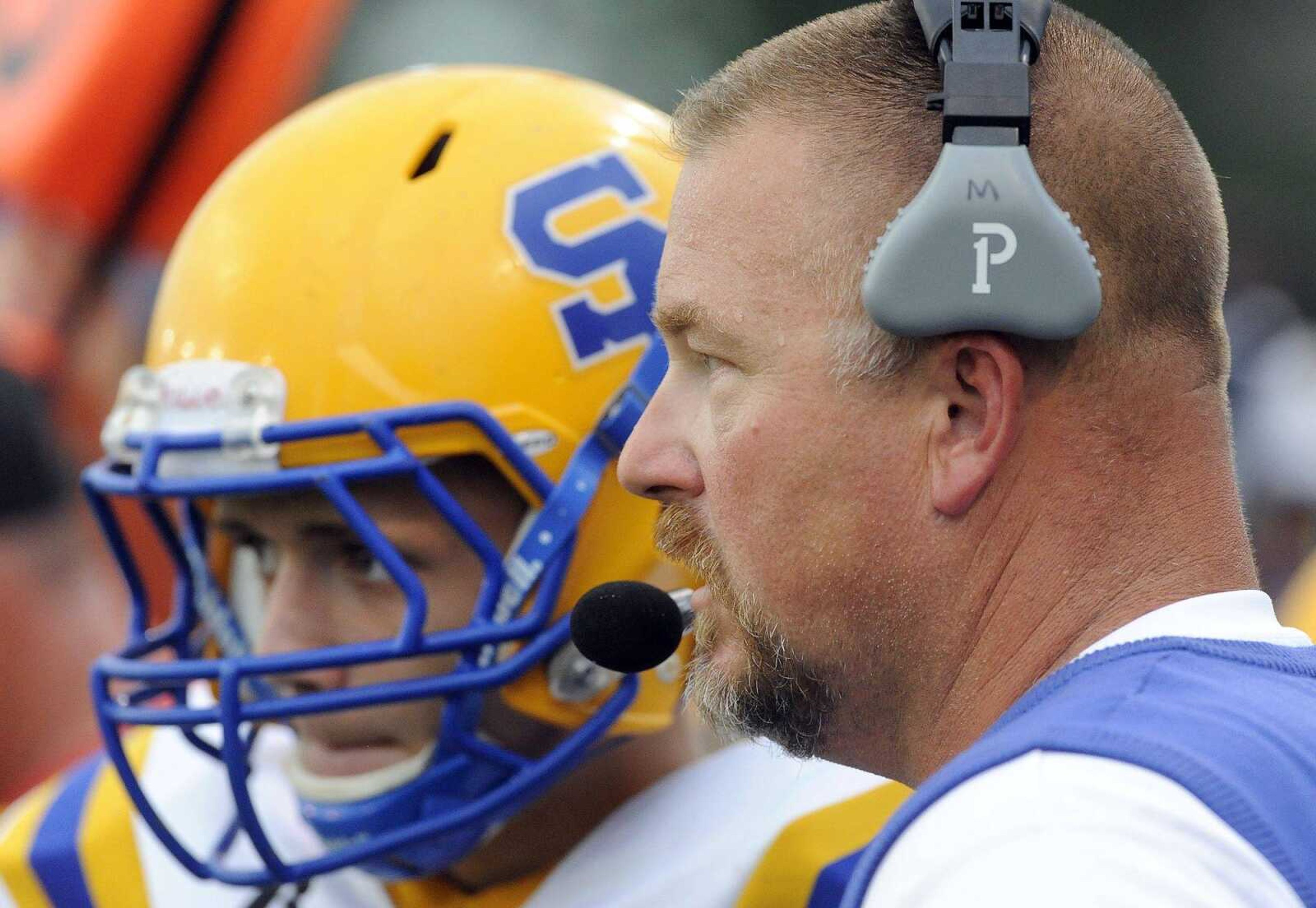 Scott City coach Jim May talks to Eli Berry on the sideline during the first quarter of the St. Vincent football game Friday, Aug. 26, 2016 in Perryville, Missouri.