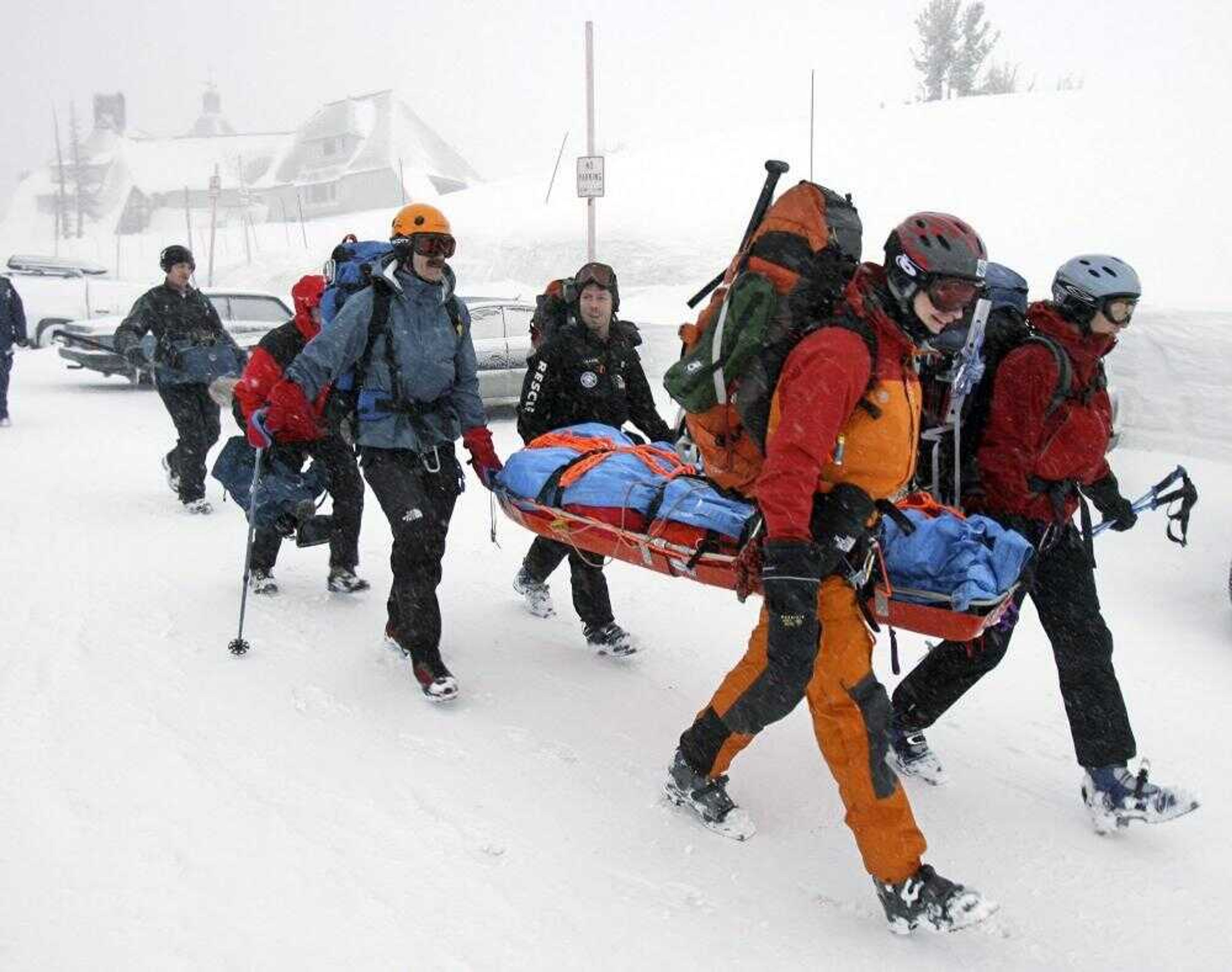 A rescue team left Timberline Lodge to try to find three injured climbers Monday,on Mount  Hood, Ore. Rescuers set out at daybreak Monday to try to reach three climbers who fell from a snowy ledge and were huddled in sleeping bags and cuddled with a dog amid ferocious winds and blowing snow. (Doug Beghtel ~ The Oregonian)