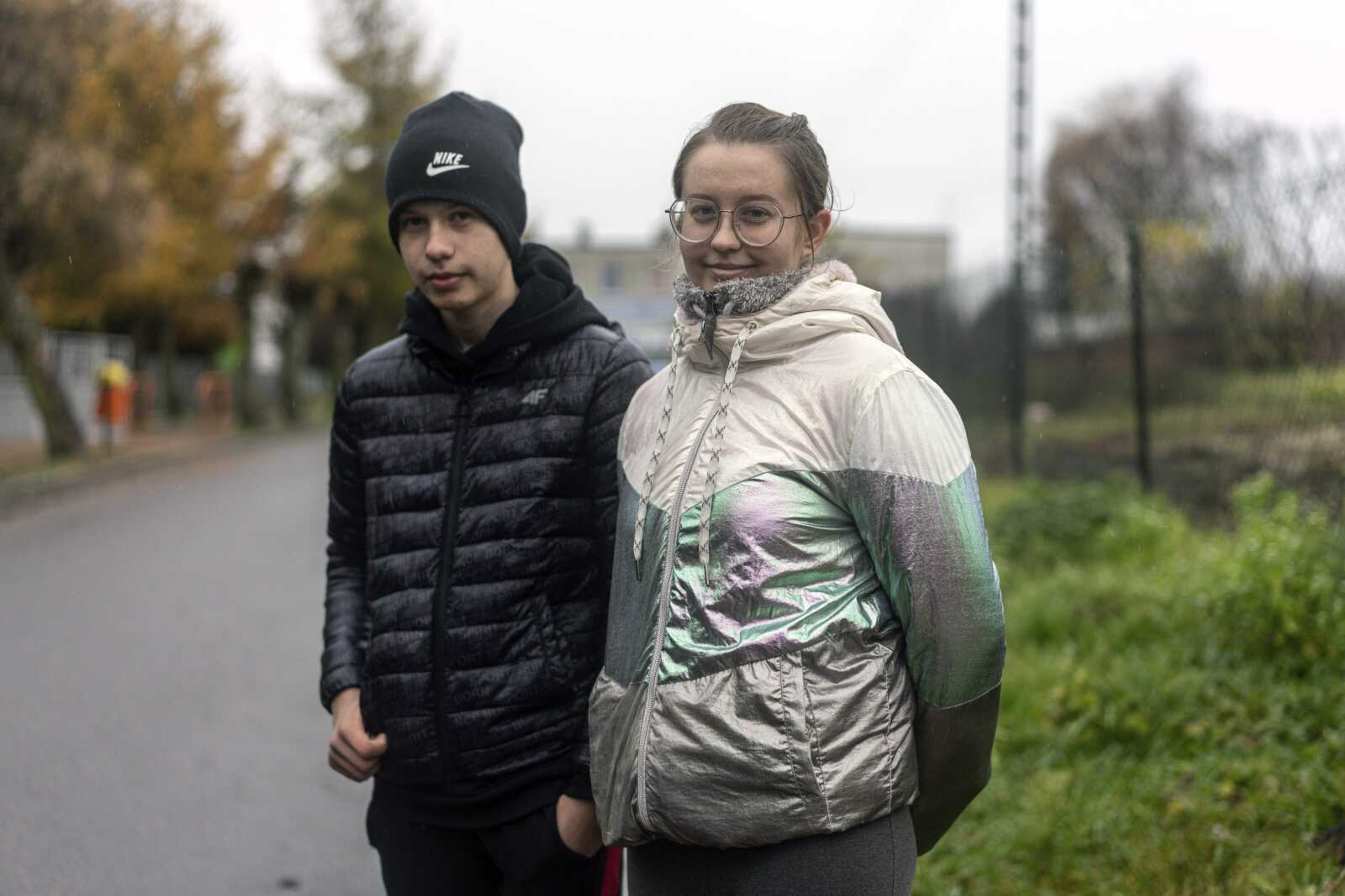 Kinga Kancir, 24, right, speaks Wednesday, Nov. 16, to an Associated Press journalist near the place where a missile struck, killing two people in a farmland at the Polish village of Przewodow, near the border with Ukraine.