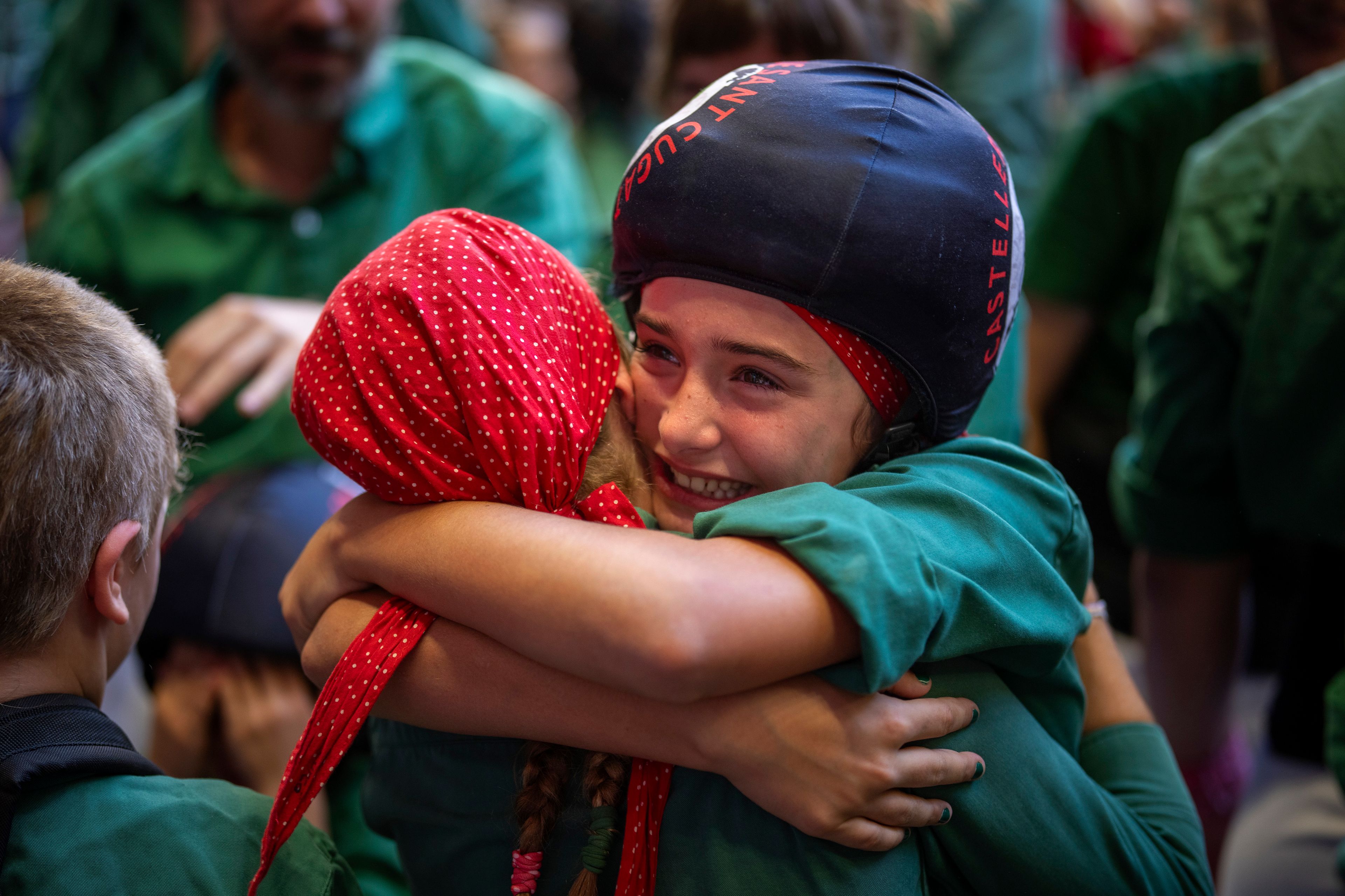 Valeria, 11, reacts after climbing to the top of a "castell" or human tower during the 29th Human Tower Competition in Tarragona, Spain, Saturday, Oct. 5, 2024. (AP Photo/Emilio Morenatti)