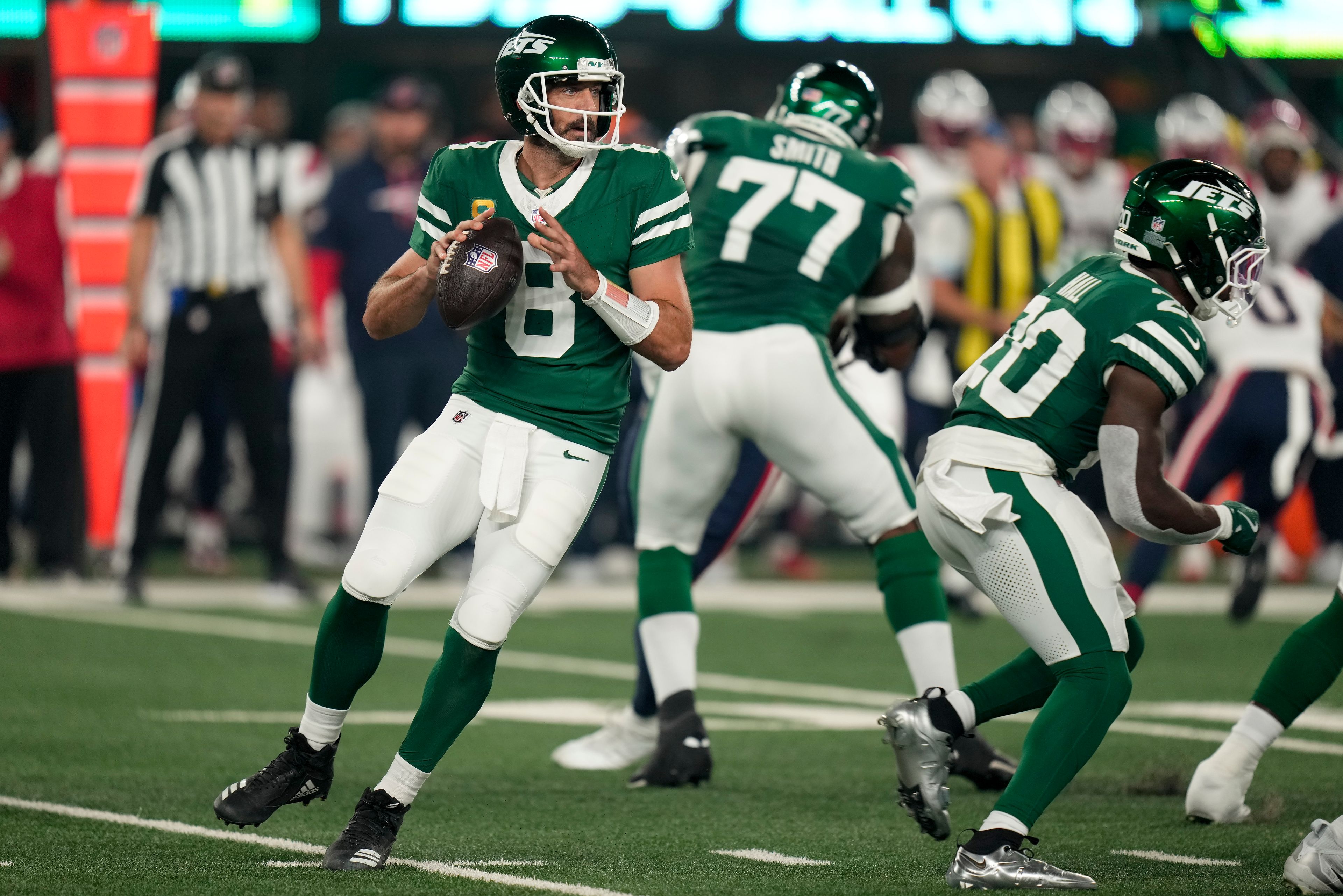 New York Jets quarterback Aaron Rodgers (8) steps back to pass against the New England Patriots during the first quarter of an NFL football game, Thursday, Sept. 19, 2024, in East Rutherford, N.J. (AP Photo/Seth Wenig)