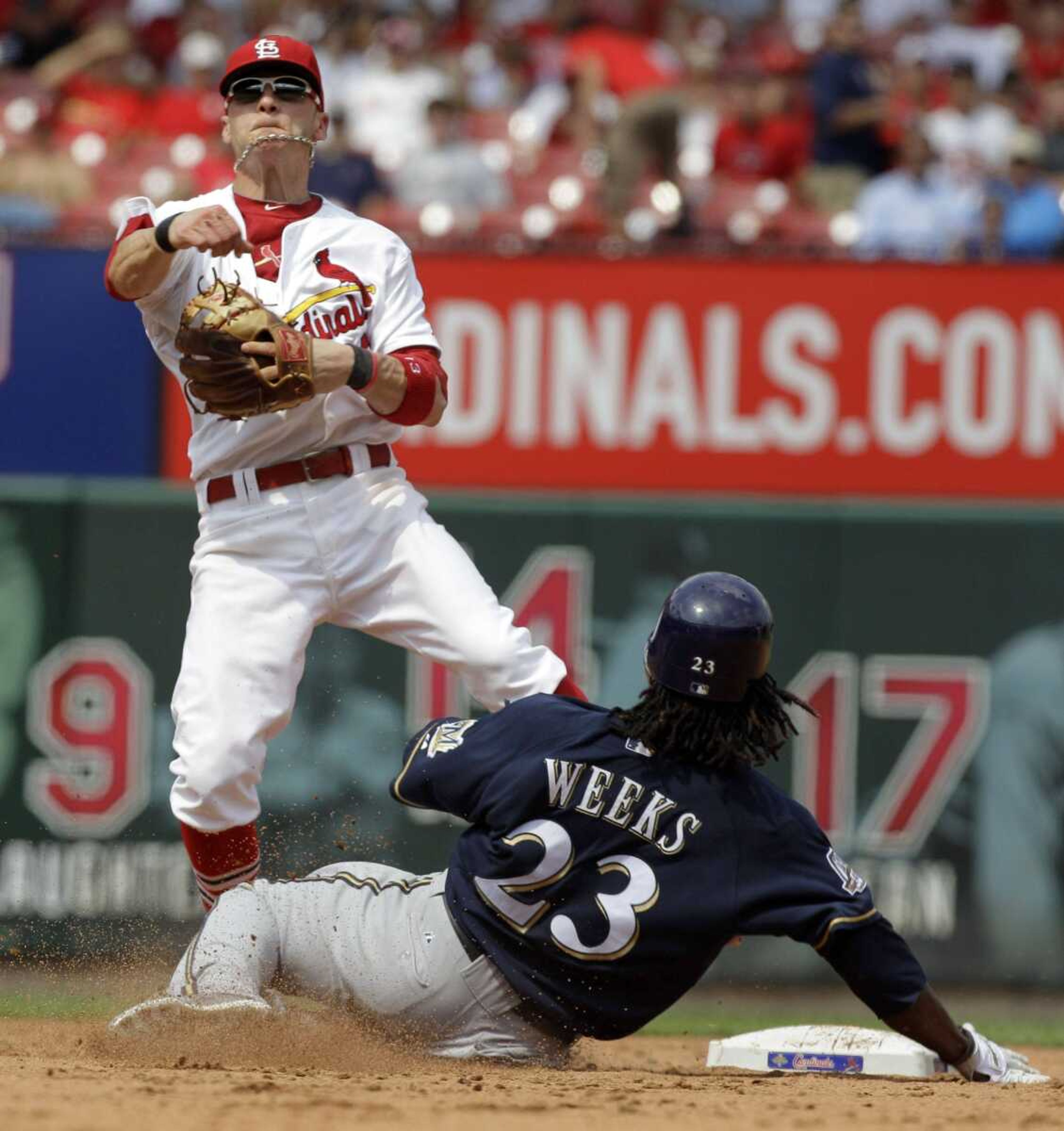 Cardinals shortstop Brendan Ryan watches his throw to first as Brewers base runner Rickie Weeks arrives at second after being forced out during the sixth inning Wednesday in St. Louis. (JEFF ROBERSON ~ Associated Press)