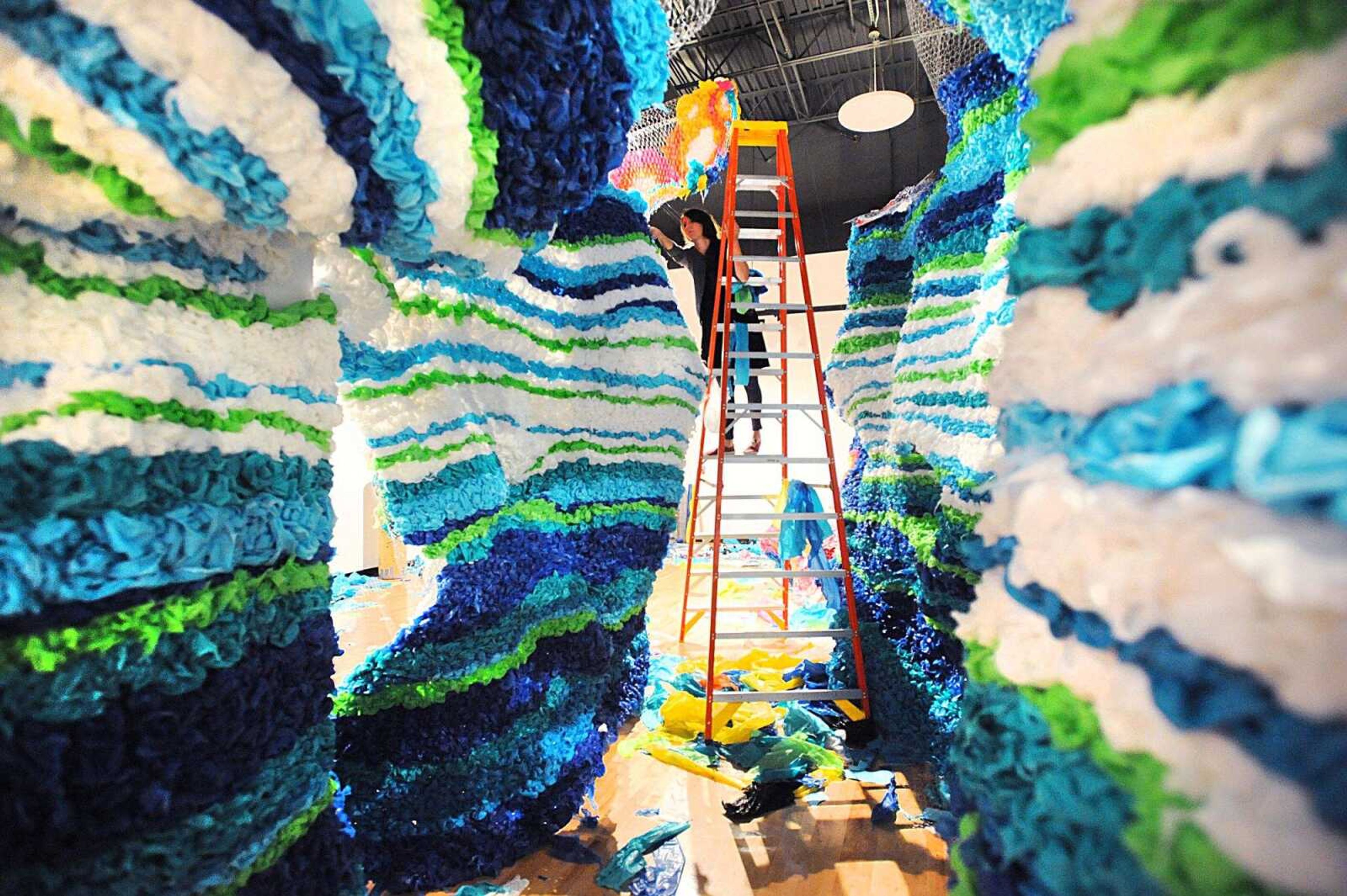 Crystal Wagner works on her installation, "Immersion," Thursday inside the Crisp Museum on the River Campus of Southeast Missouri State University. (Laura Simon)