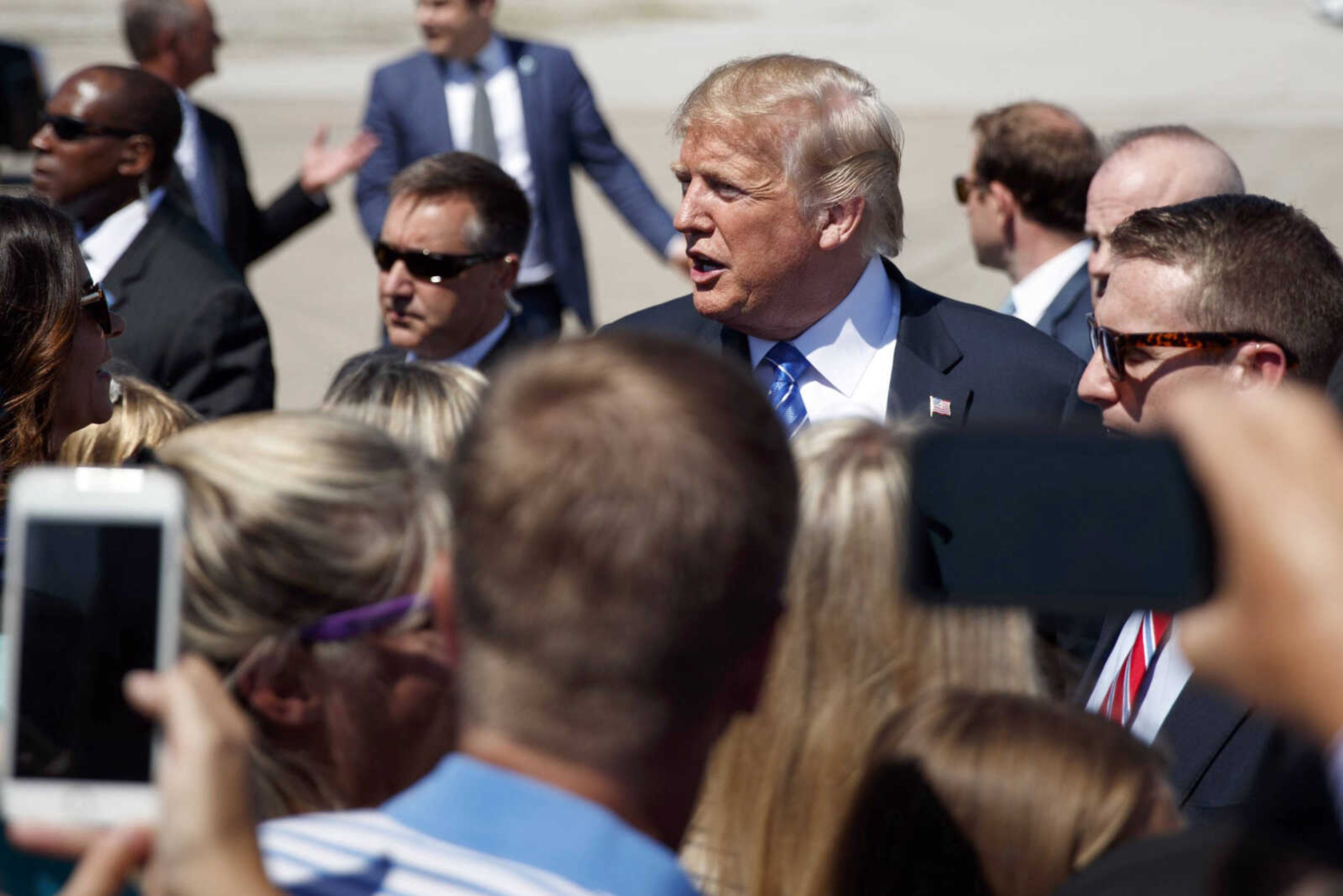 President Donald Trump greets supporters Tuesday after arriving at the Kansas City International Airport to attend the national convention of the Veterans of Foreign Wars in Kansas City, Missouri.