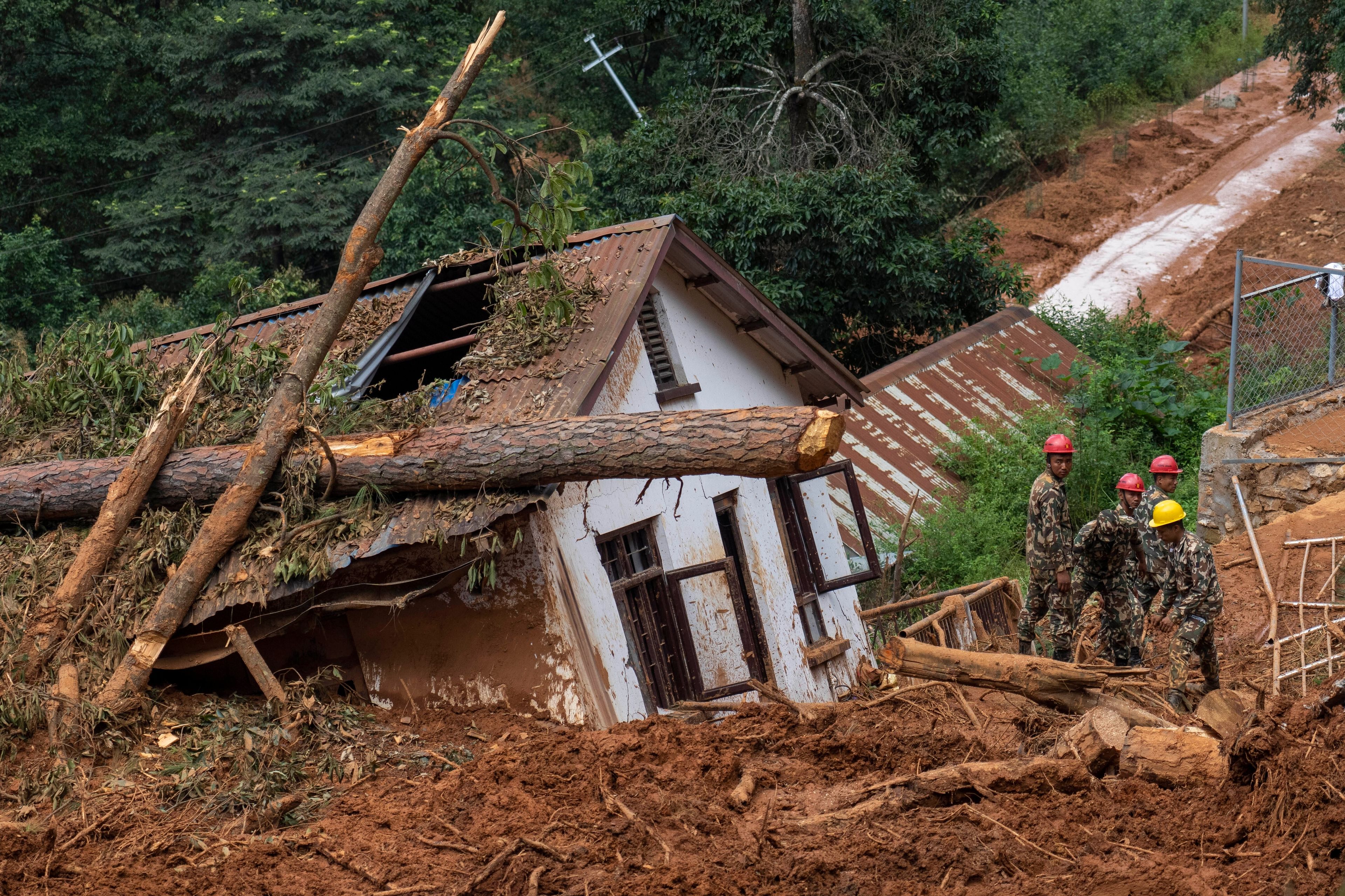 FILE - Rescuers search for the body of a missing doctor at the site of a landslide in Anandaban hospital, in the aftermath of a flood caused by heavy rains, in Lalitpur, Nepal, Oct. 1, 2024. (AP Photo/Niranjan Shrestha, File)