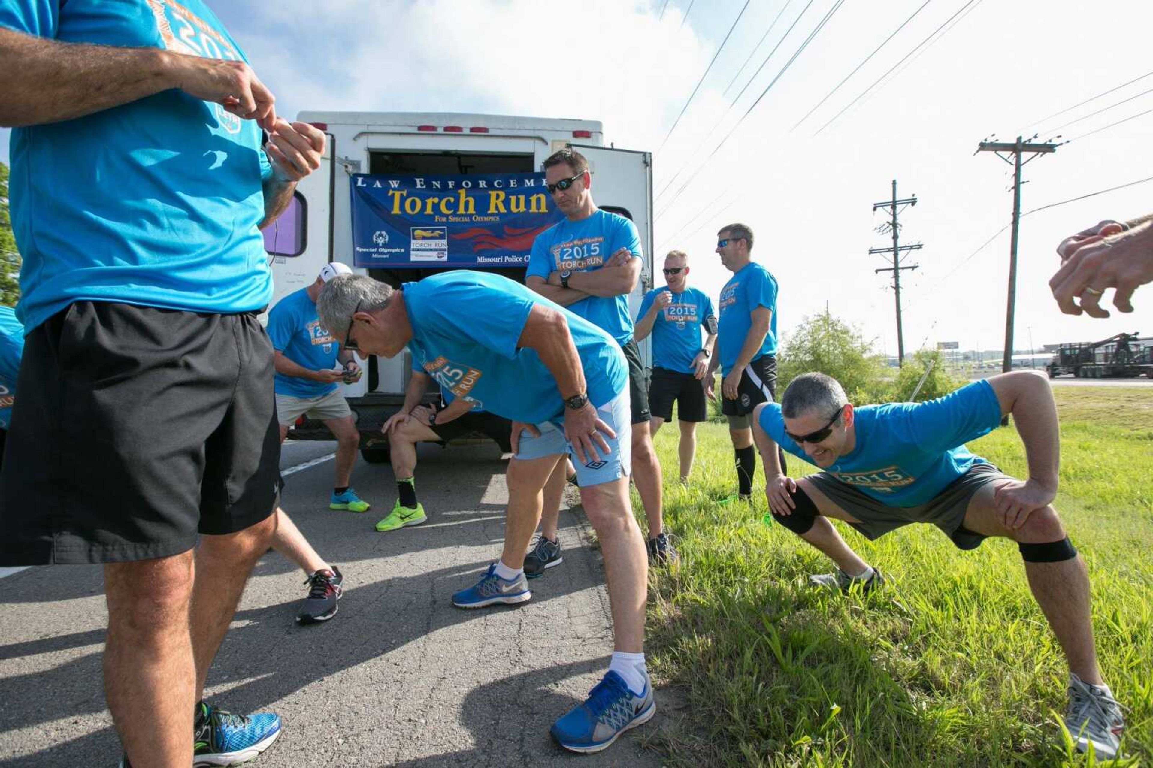 Members of the Cape Girardeau Police Department limber up Thursday morning before heading north on Kingshighway during a 5-kilometer leg of the Region 9 Special Olympics Torch Run. The run covers more than 950 miles and ends at the site of the State Summer Games. (Glenn Landberg)