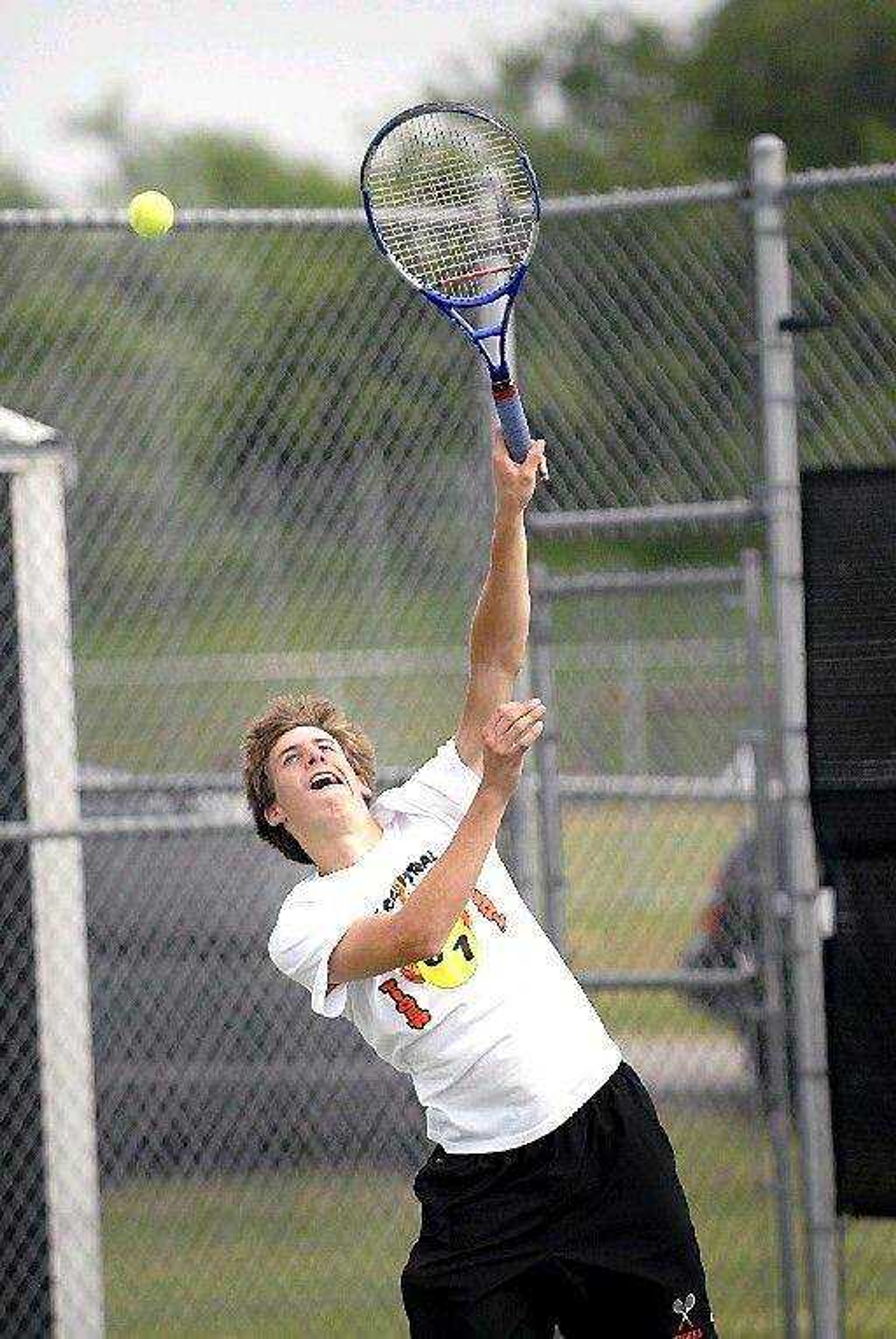 David Berry serves for Central during doubles play with Patrick Duffy against Eureka on Tuesday at Central High. Berry and Duffy won their doubles match, and both won their singles matches. (Kit Doyle)