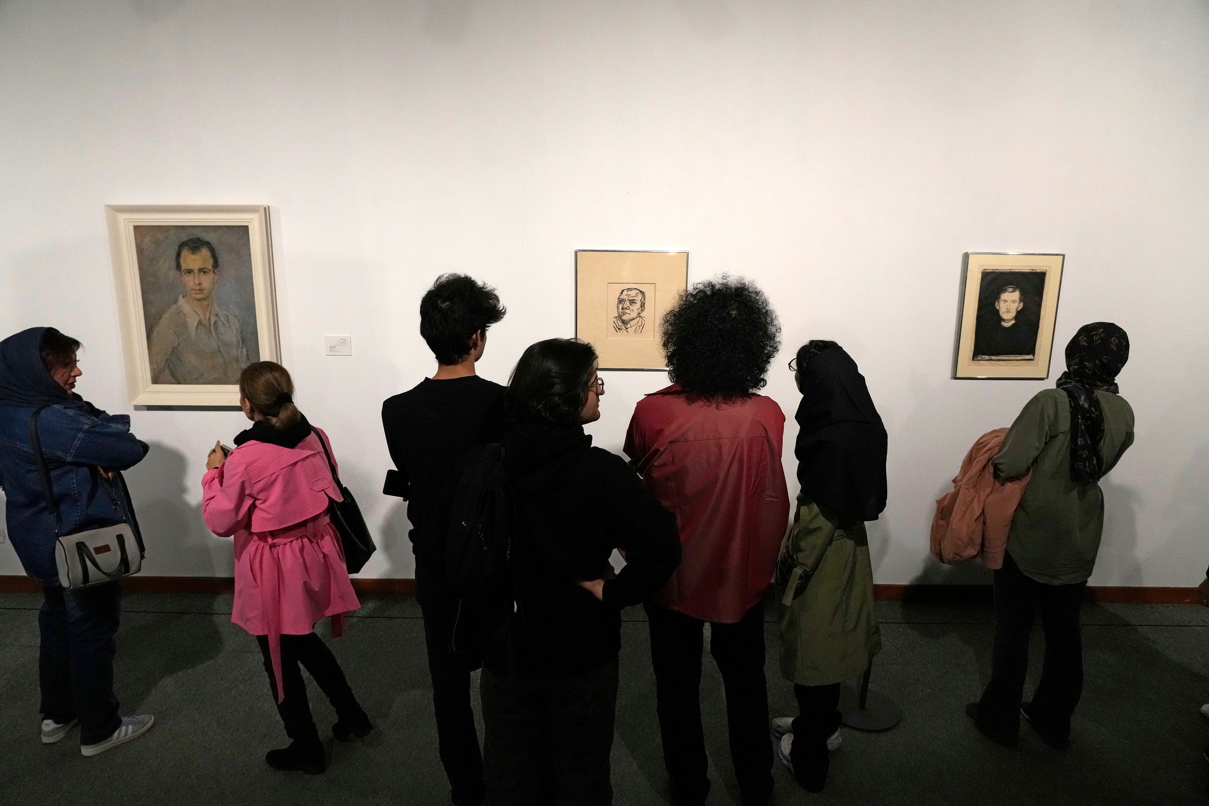 People visit an exhibition titled Eye to Eye which showcases over 120 works by modern world artists as well as Iranian painters at Tehran Museum of Contemporary Art, in Tehran, Thursday, Nov. 21, 2024. (AP Photo/Vahid Salemi)