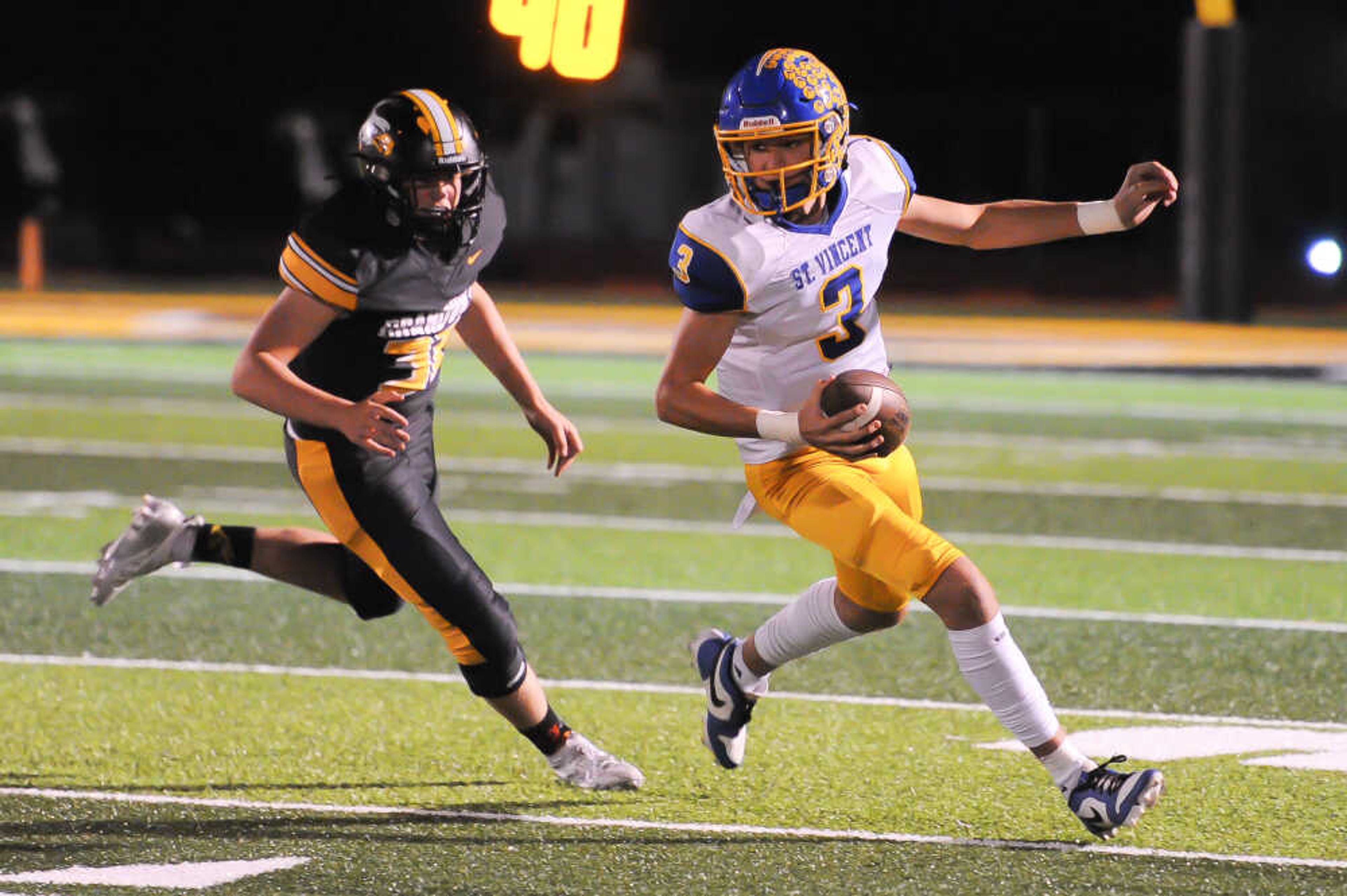 St. Vincent's Nick Buchheit, right, evades a tackler during a game between the Grandview Eagles and the St. Vincent Indians on Friday, Oct. 18, at Grandview High School in Hillsboro. St. Vincent defeated Grandview 42-20.