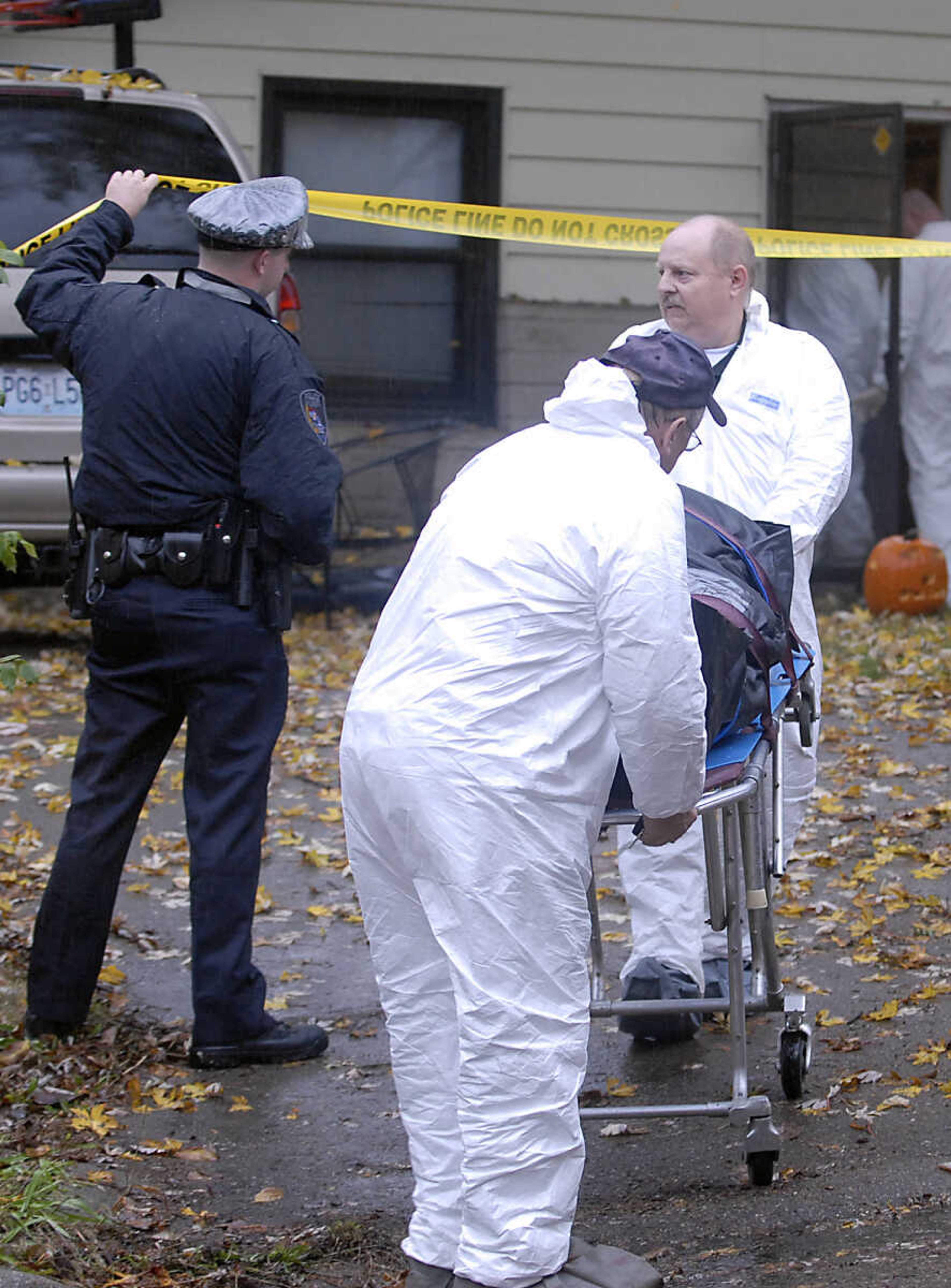 KIT DOYLE ~ kdoyle@semissourian.com
Authorities move a victim's body from 1224 N. Missouri St. to a the Coroner's vehicle Tuesday morning, October 27, 2009, in Cape Girardeau.  There was a double homicide at the residence early Tuesday morning.