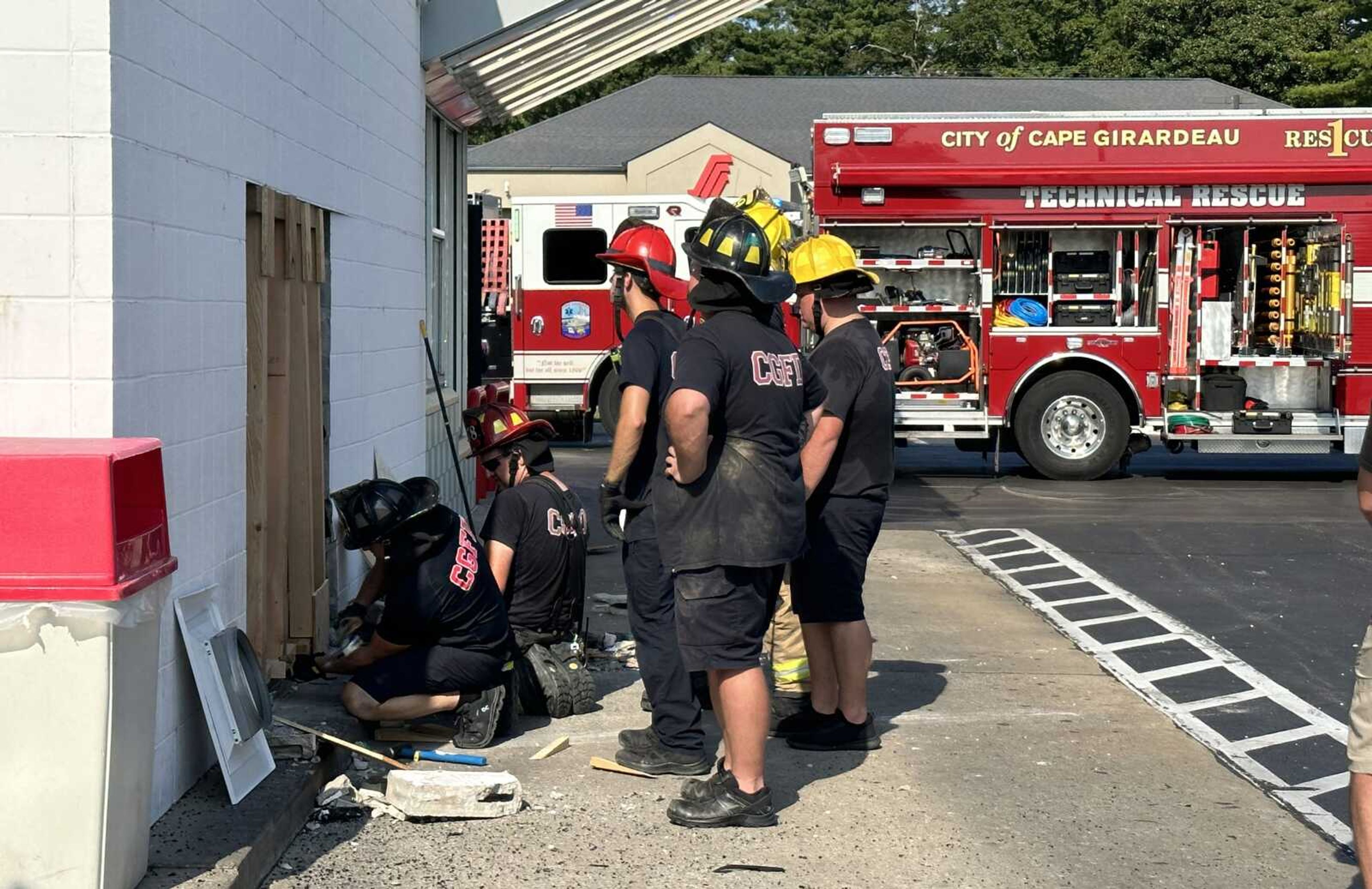 Cape Girardeau Fire Department personnel work Monday afternoon, Sept. 4, to patch the side of the Andy's Frozen Custard building in Cape Girardeau after a vehicle backed into the building, creating a sizable hole in its southern wall. Bobby Newton, spokesman for Cape Girardeau Police Department, said a vehicle backed into the building. No one was injured in the incident.