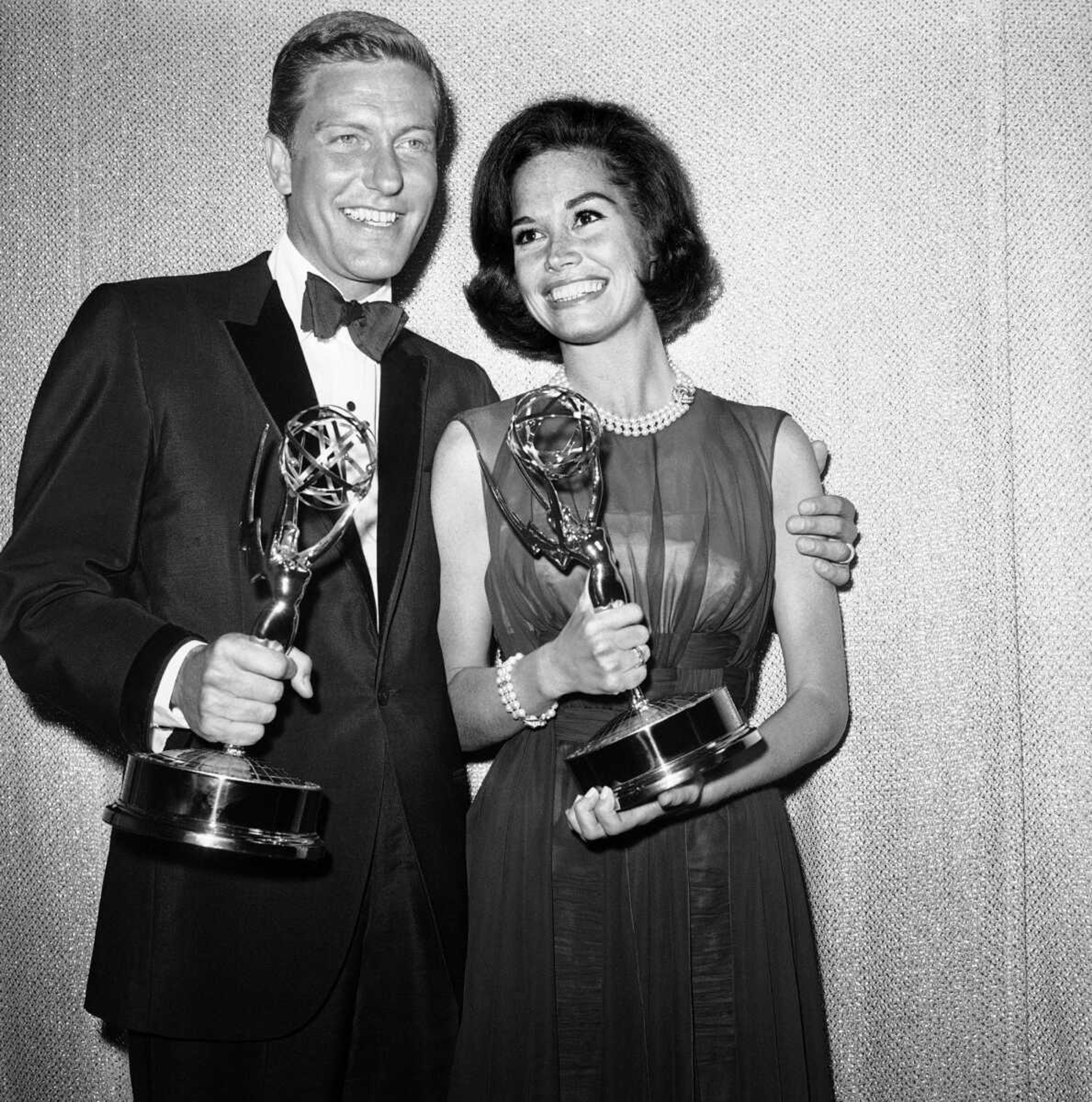 This photo shows Dick Van Dyke, left, and Mary Tyler Moore, co-stars of "The Dick Van Dyke Show," backstage at the Palladium with their Emmys for best actor and actress in a series at the Television Academy's 16th annual awards show May 25, 1964, in Los Angeles.