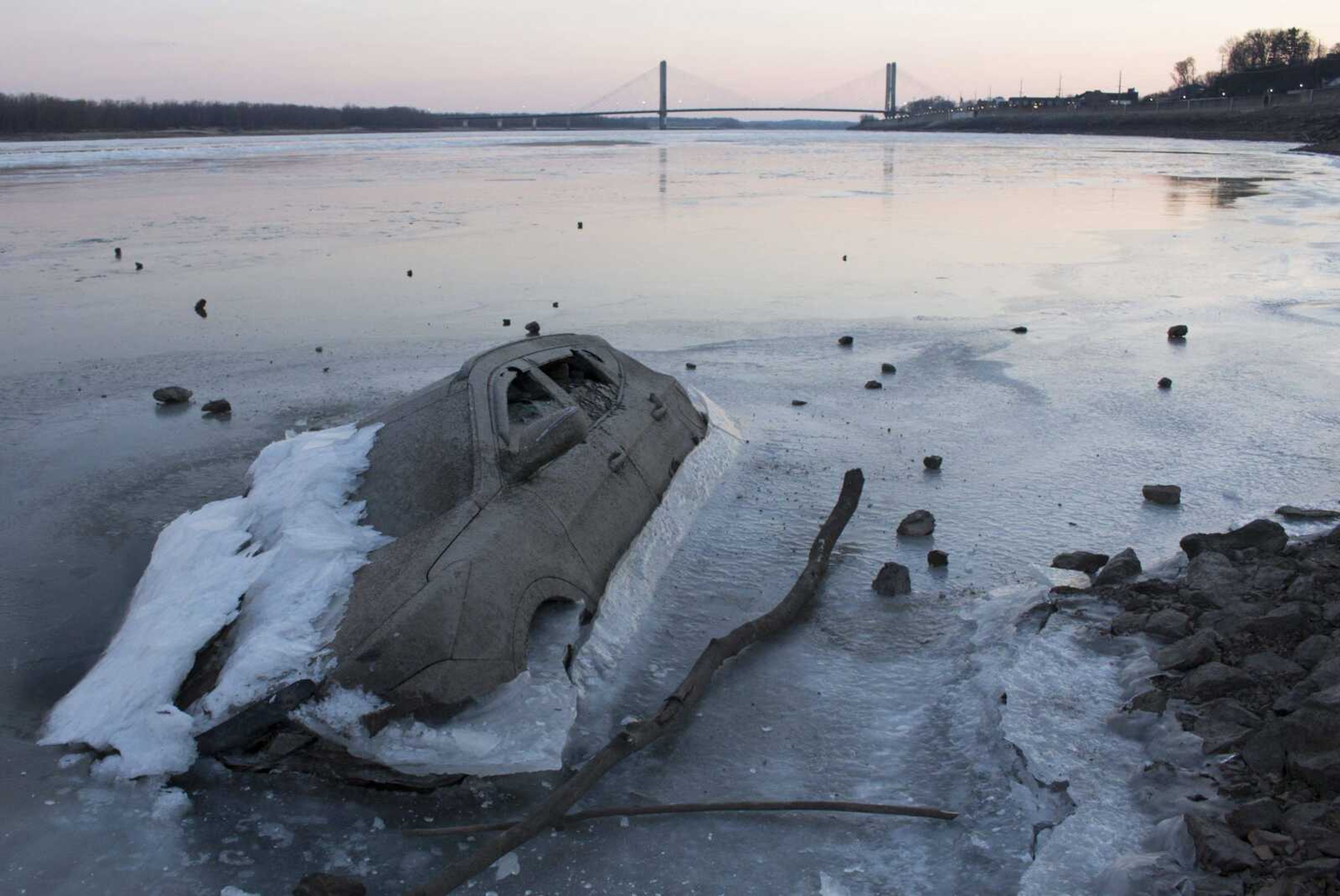 A sunken vehicle protrudes through a frozen section of the Mississippi River on Jan. 3, 2018, in Cape Girardeau.