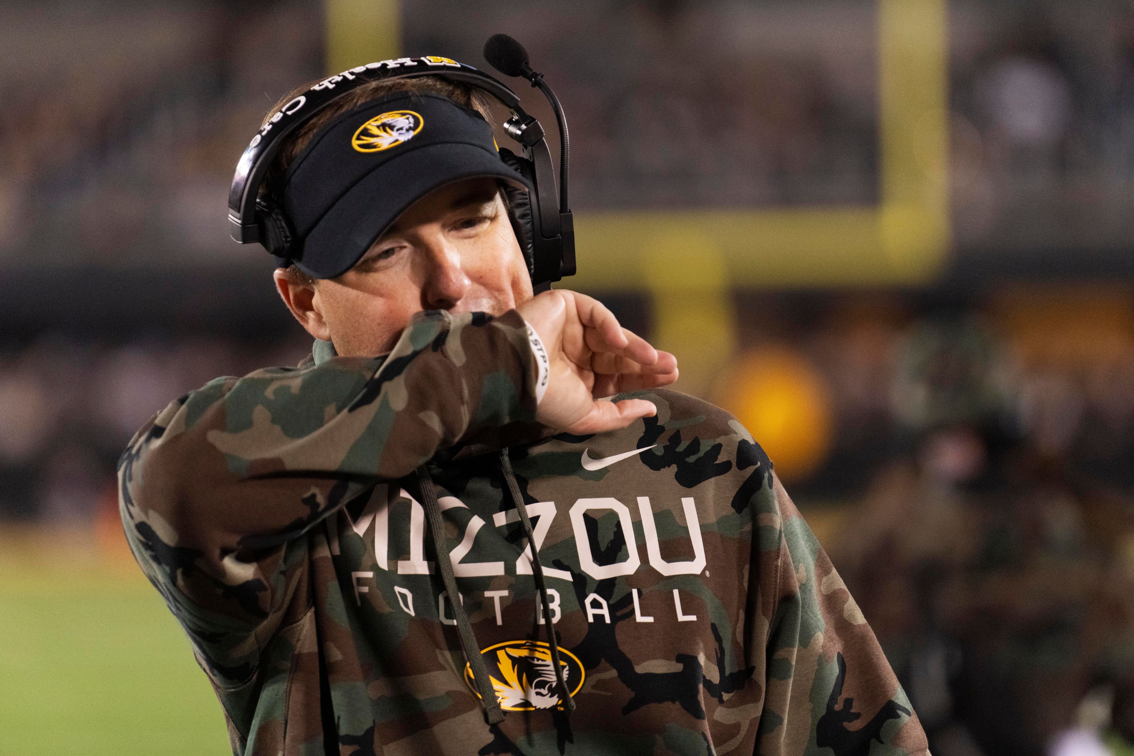 Missouri head coach Eliah Drinkwitz wipes his face as he paces the sideline during the first half of an NCAA college football game against Oklahoma Saturday, Nov. 9, 2024, in Columbia, Mo. (AP Photo/L.G. Patterson)