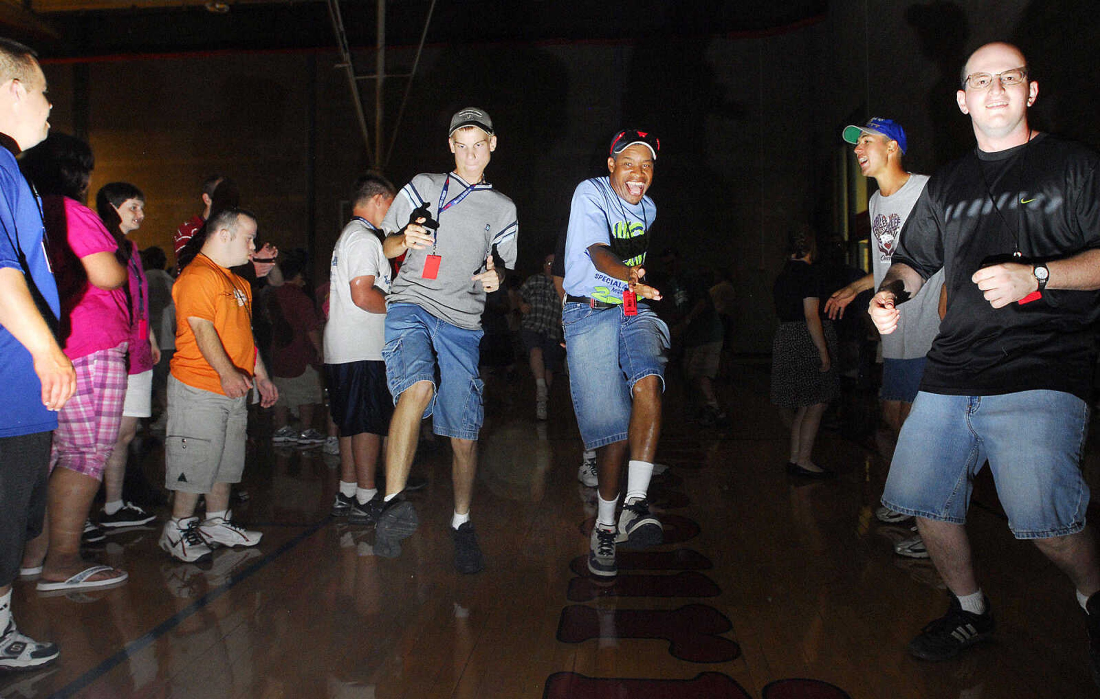 LAURA SIMON~lsimon@semissourian.com
Special Olympic athlete Daniel Crane, left, and Arthur Murphy dance through an aisle of athletes Saturday, August 14, 2010 during the Special Olympics dance at SEMO Student Recreation Center.