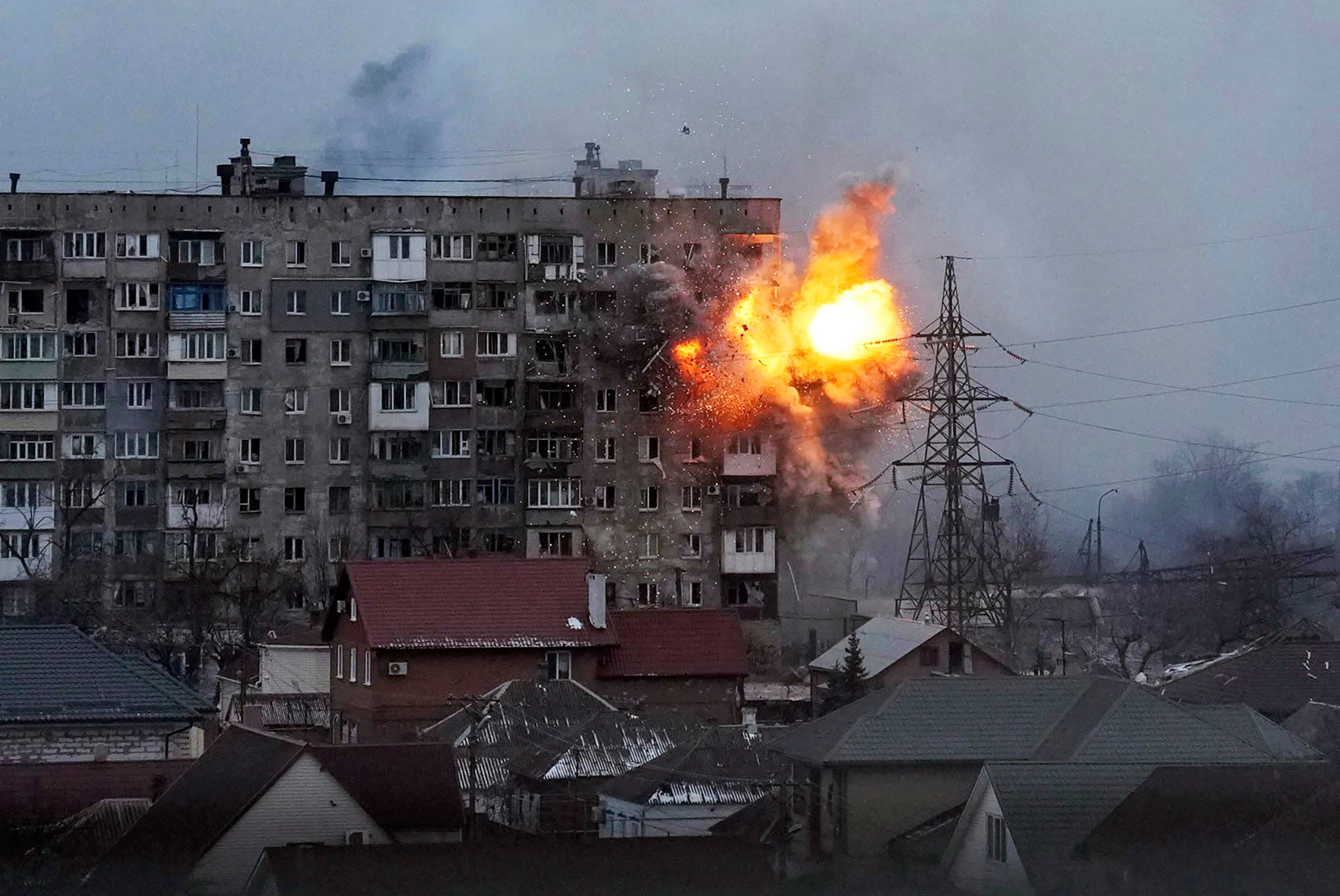 FILE - An explosion is seen in an apartment building after Russian's army tank fires in Mariupol, Ukraine, Friday, March 11, 2022. (AP Photo/Evgeniy Maloletka, File)