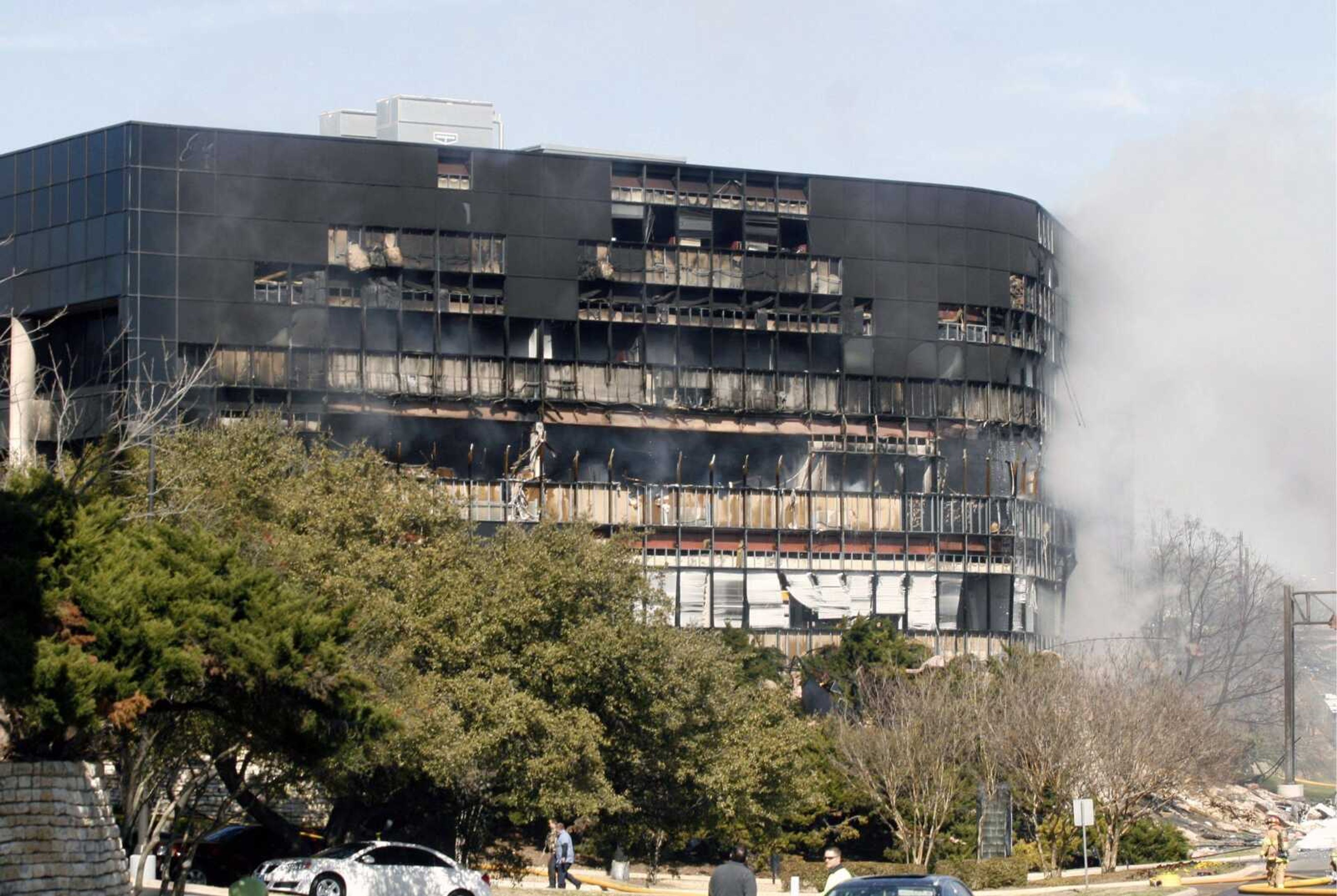 Smoke billows from a seven-story building after a small private plane crashed into the building  in Austin, Texas on Thursday Feb. 18, 2010.  (AP Photo/Jack Plunkett)