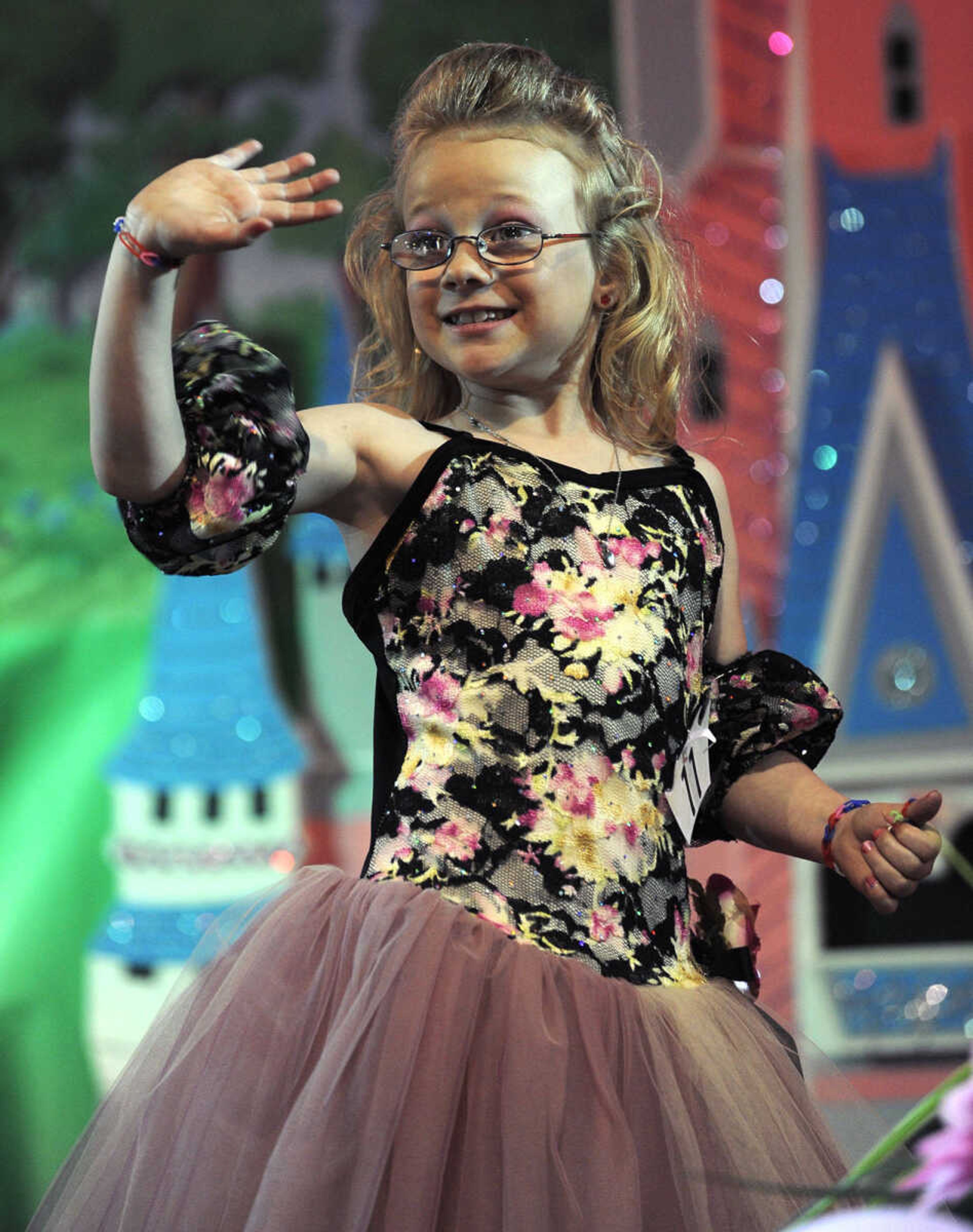 Micah Joyce waves to the crowd in the 5-9 age division of the S. E. Missouri Angels Pageant on Saturday, April 26, 2014 at Scott City High School.