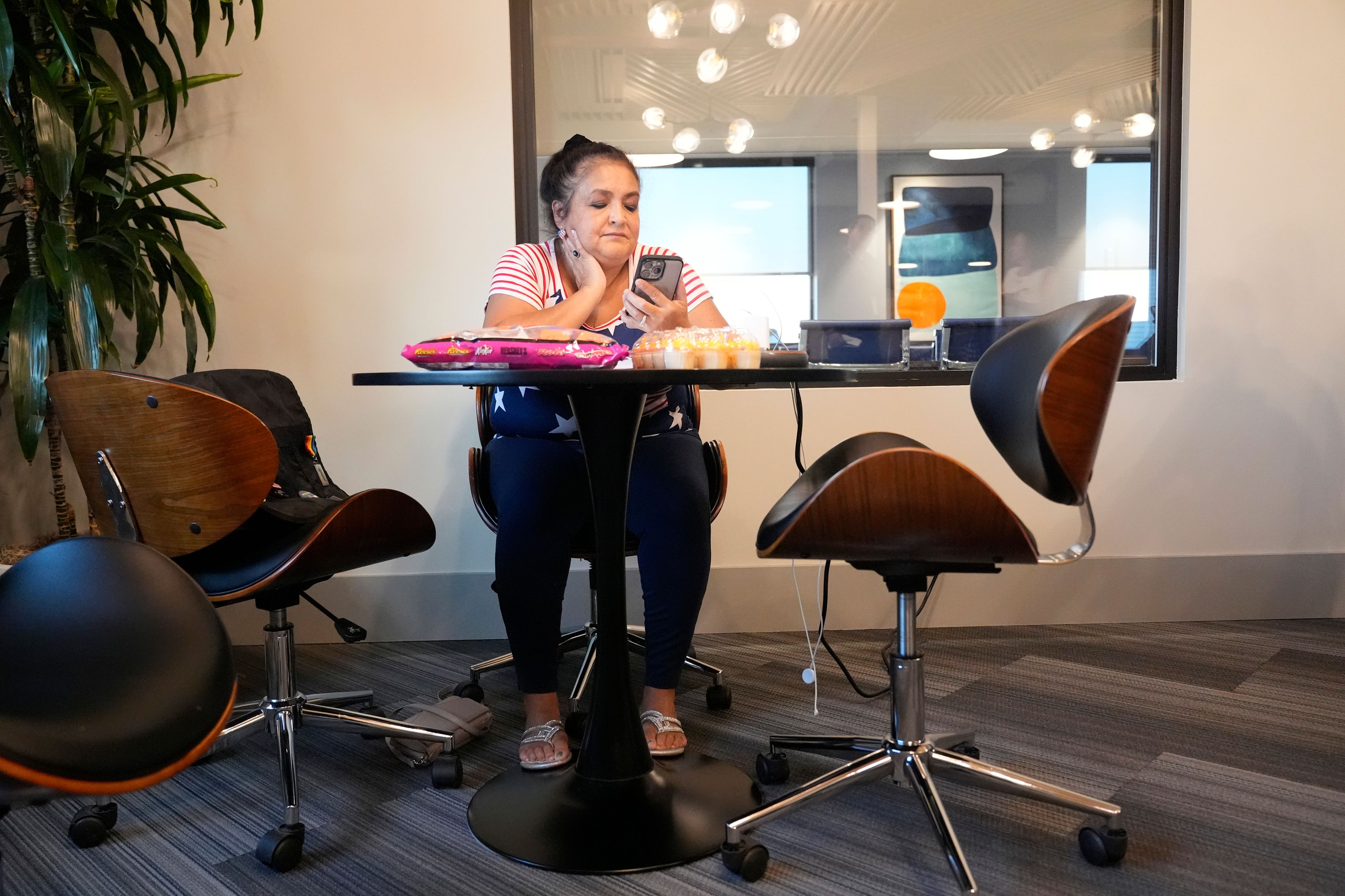 Sally Ortega Putney works a volunteer phone bank calling potential voters in Flower Mound, Texas, Wednesday, Oct. 2, 2024. (AP Photo/LM Otero)