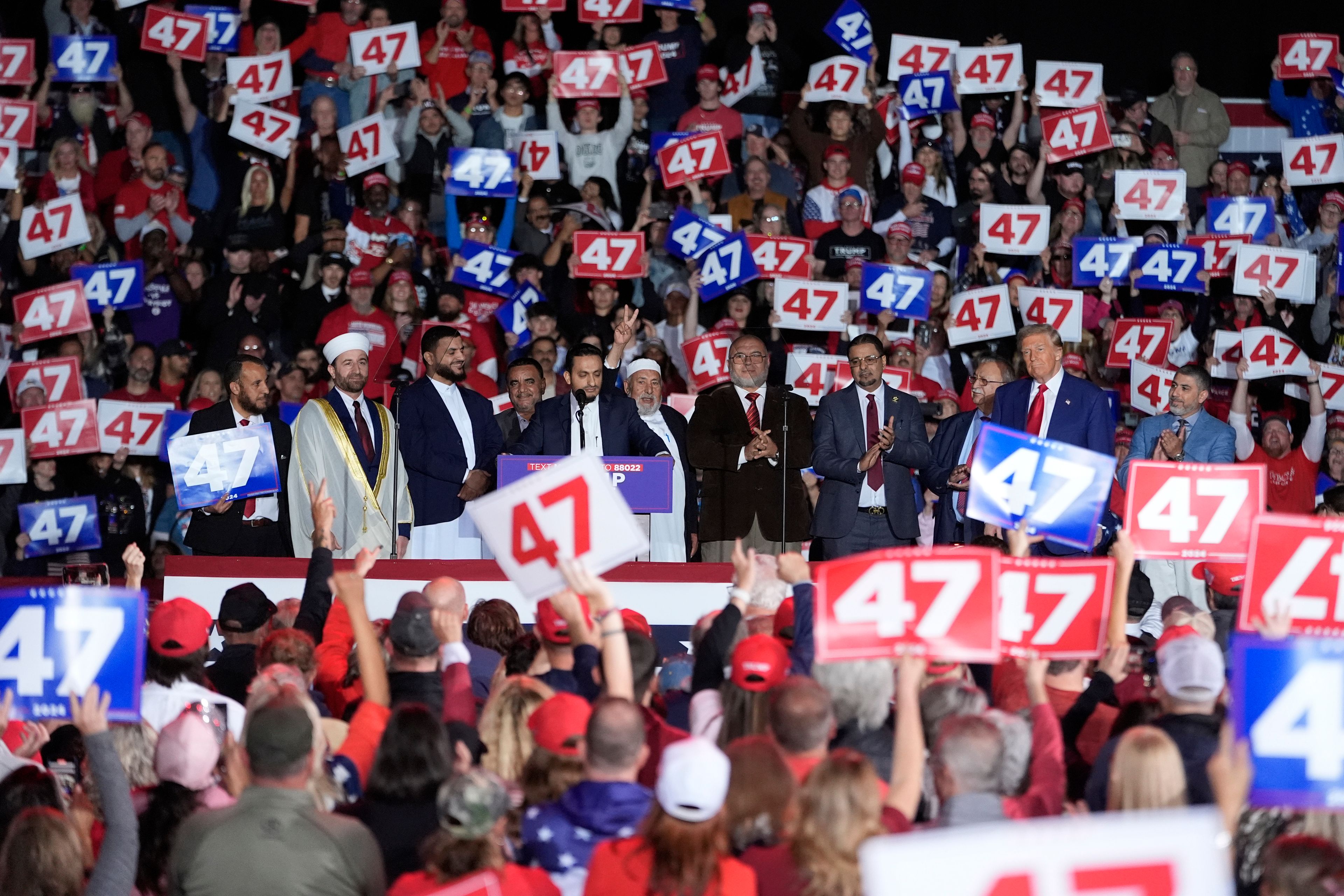 Republican presidential nominee former President Donald Trump, right, stands alongside local Muslim leaders during a campaign rally at the Suburban Collection Showplace, Saturday, Oct. 26, 2024 in Novi, Mich. (AP Photo/Carlos Osorio)