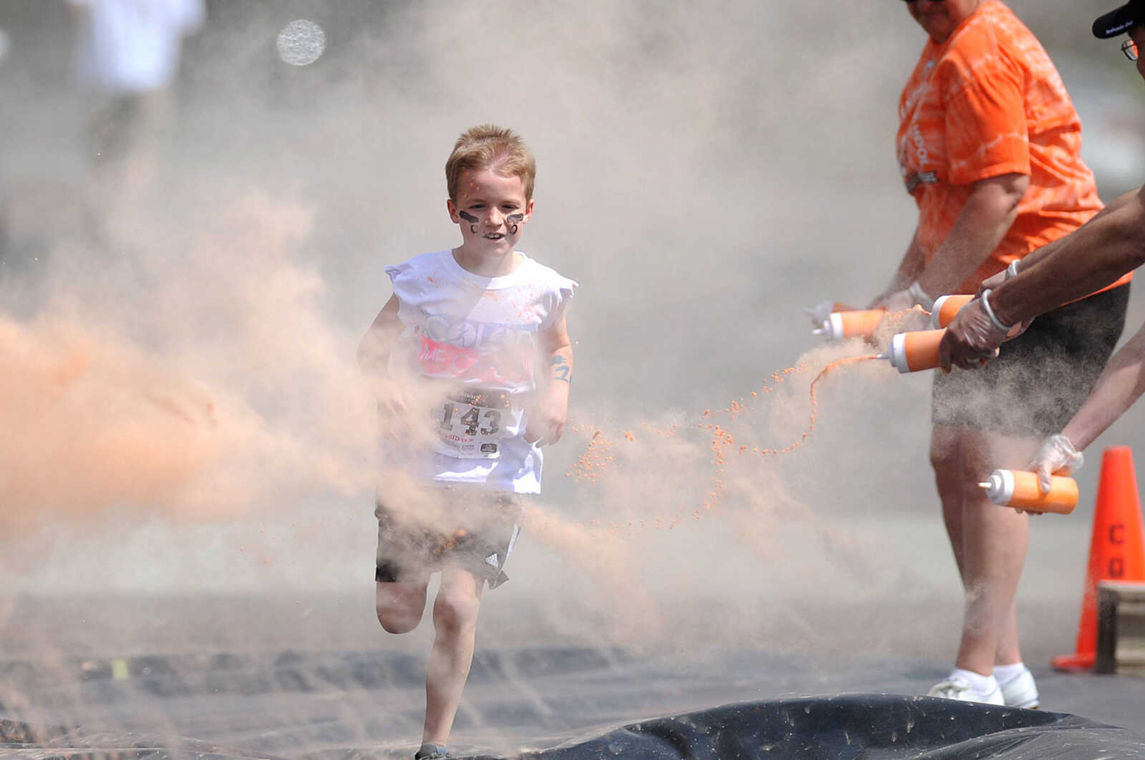 LAURA SIMON ~ lsimon@semissourian.com

Participants in the Color Me Cape 5K are sprayed with orange powder at the first color station on Good Hope Street, Saturday, April 12, 2014, in Cape Girardeau.