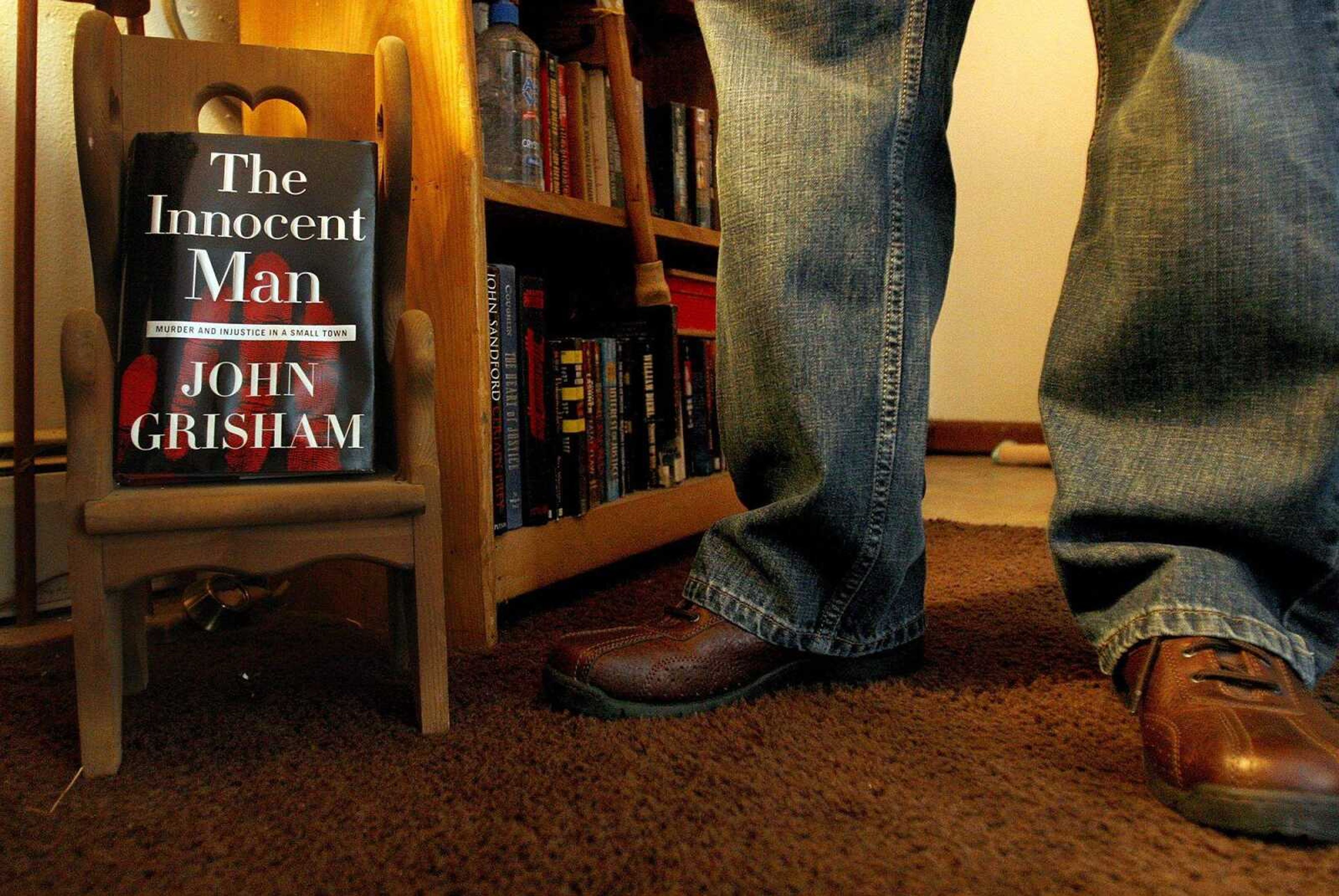 ELIZABETH DODD ~ edodd@semissourian.com
While wearing new shoes, Kezer stands next to a John Grisham novel displayed at his mother's home.