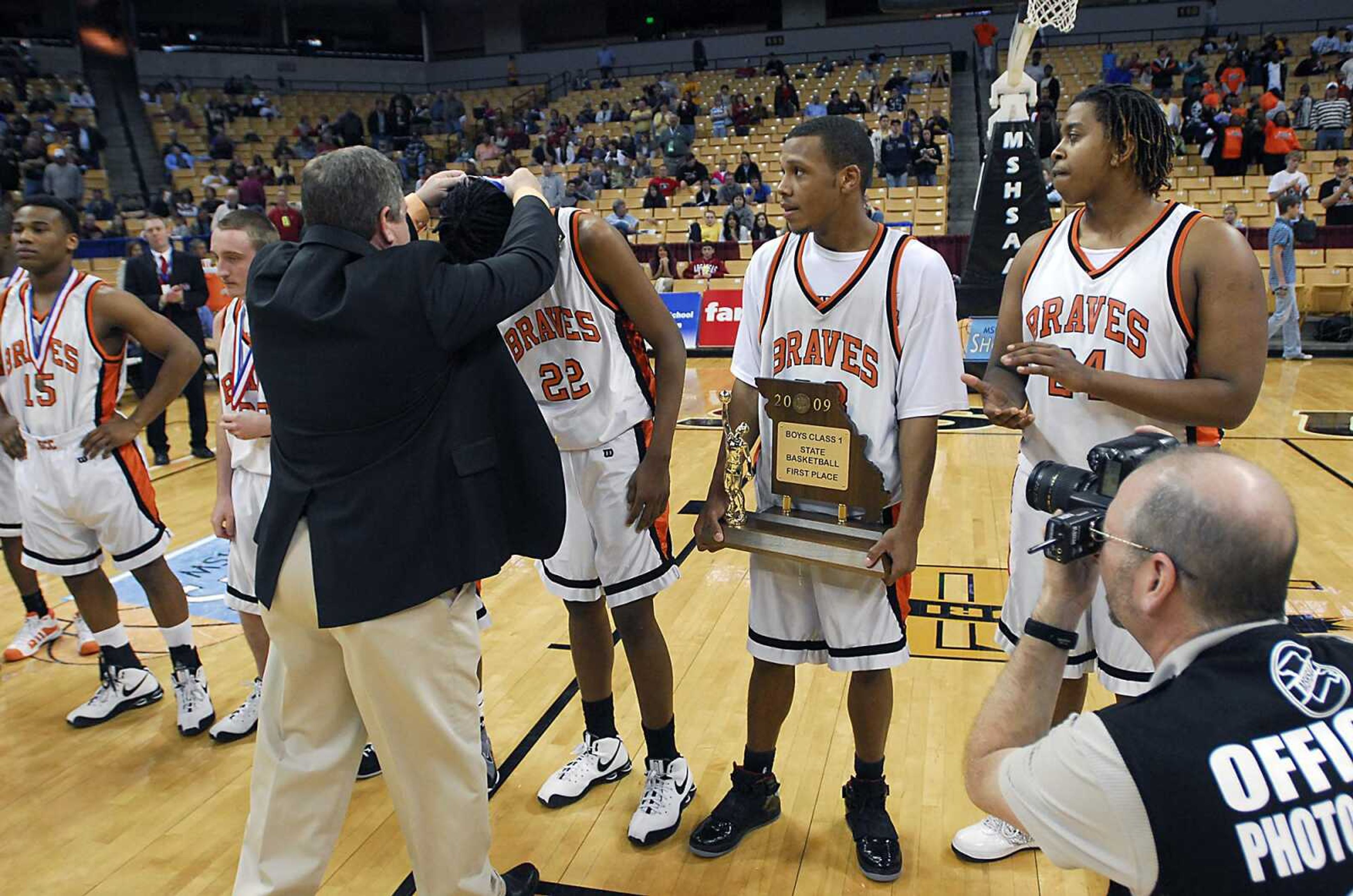 KIT DOYLE ~ kdoyle@semissourian.com
Senior Desmin Williams receives his medal as fellow senior Drew Thomas awaits his while holding the championship trophy Saturday, March 21, 2009, at Mizzou Arena.