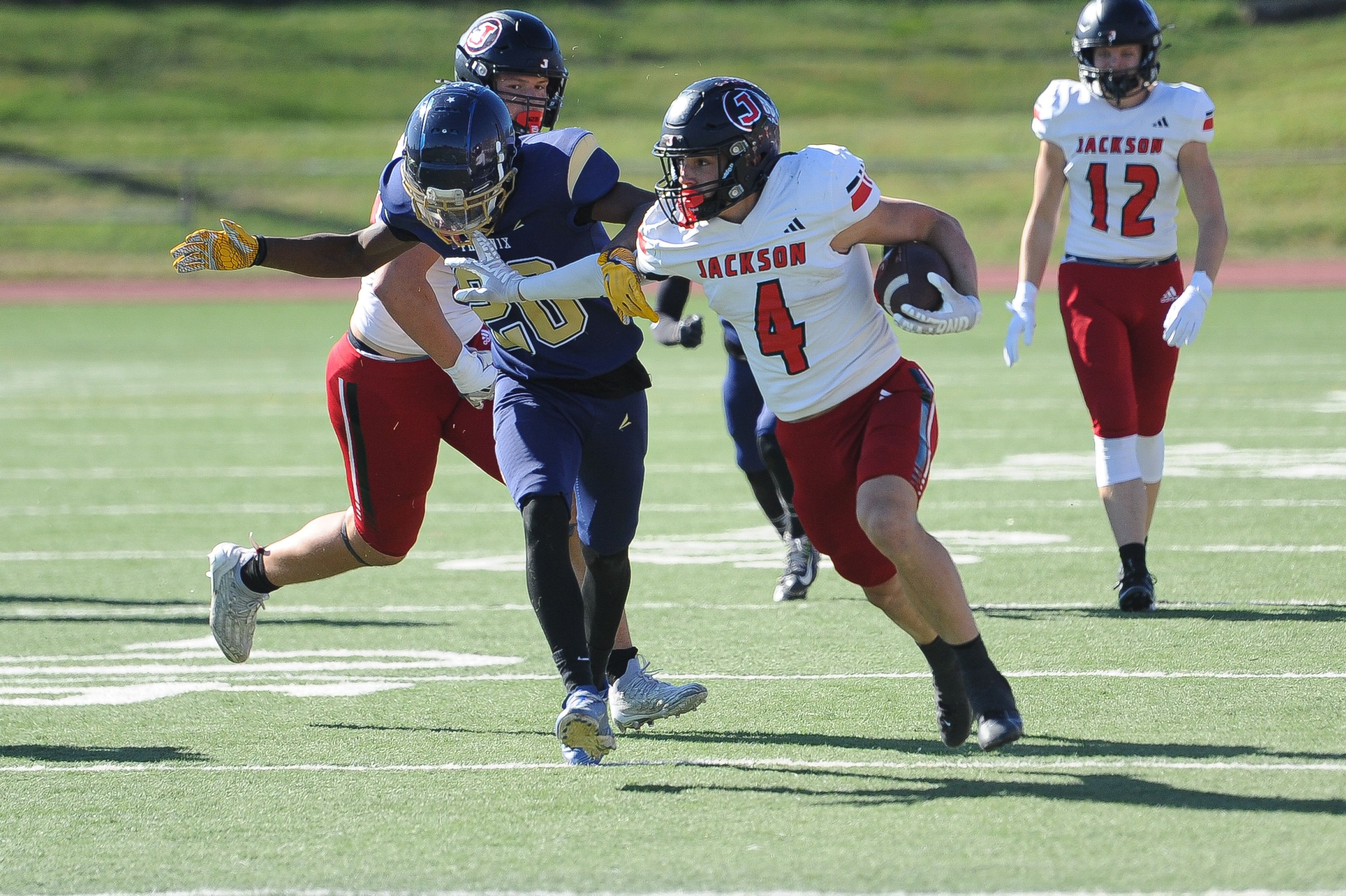 Jackson's Kai Crowe stiffs a defenders during a Saturday, October 19, 2024 game between the Miller Career/Vashon Phoenix and the Jackson Indians at Gateway STEM High School in St. Louis. Jackson defeated Miller Career, 55-14.