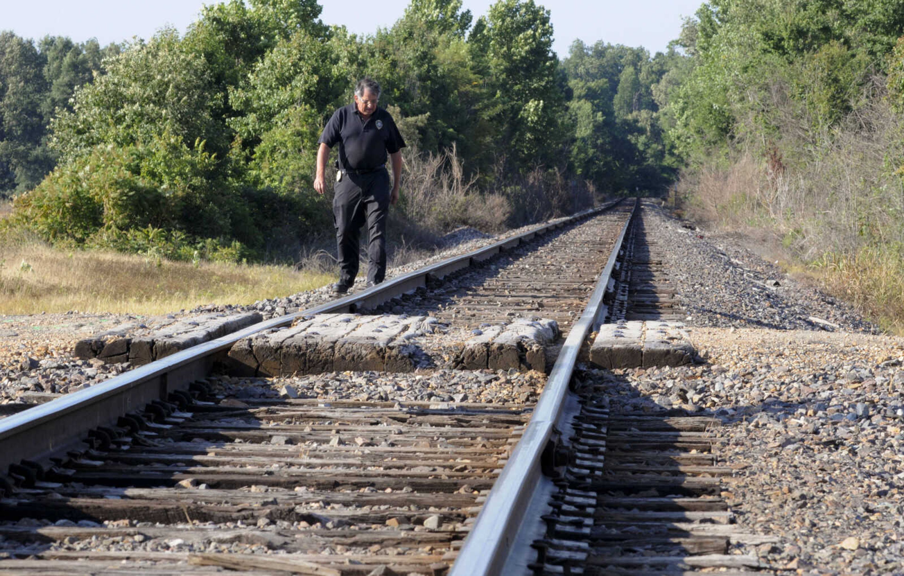 Union Pacific Railroad Special Agent Steve Ray looks for debris along a rail line just north of Poplar Bluff, Mo., Tuesday, June 5, 2012, after two teenagers were killed and another was injured when their vehicle was struck by an Amtrak train just after midnight. (AP Photo/Daily American Republic, Paul Davis)