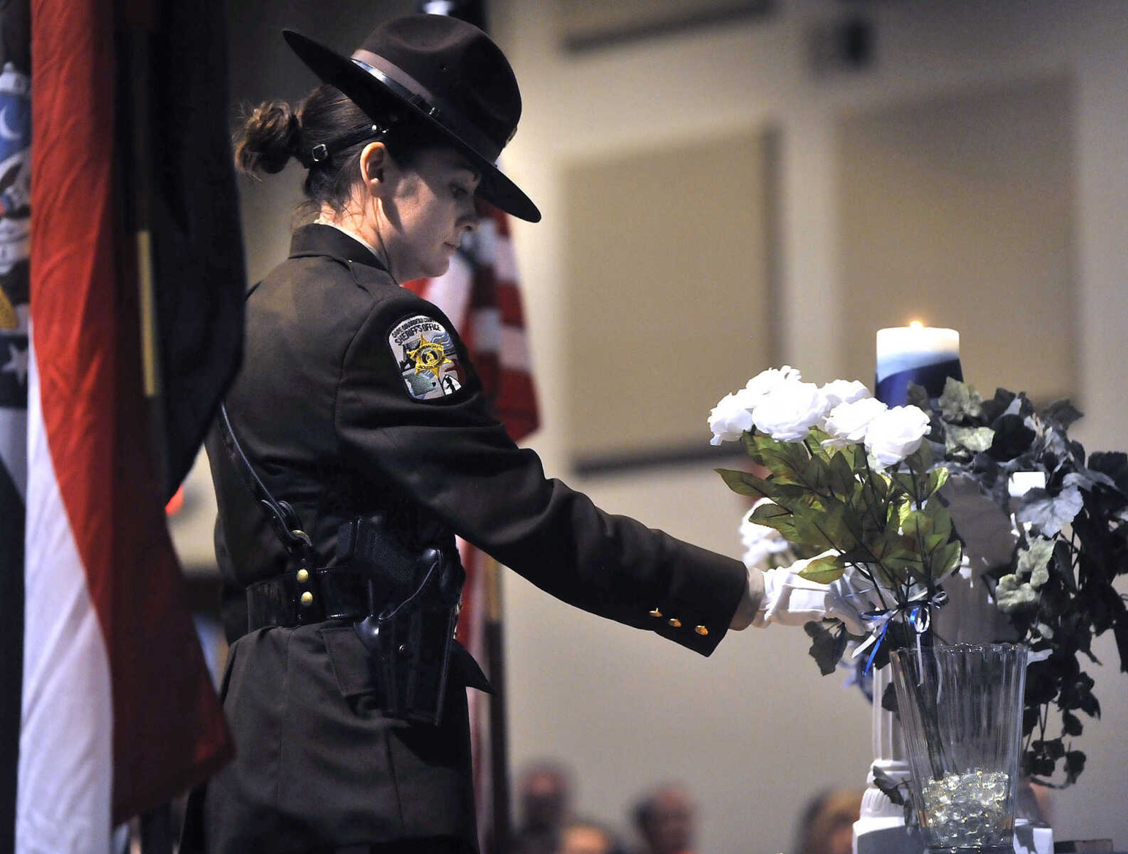 FRED LYNCH ~ flynch@semissourian.com
Deputy Carrie Berry of the Cape Girardeau County Sheriff's Office presents a rose in honor of a fallen police officer Thursday, May 25, 2017 during the 2017 Law Enforcement Memorial Ceremony at Cape Bible Chapel in Cape Girardeau.