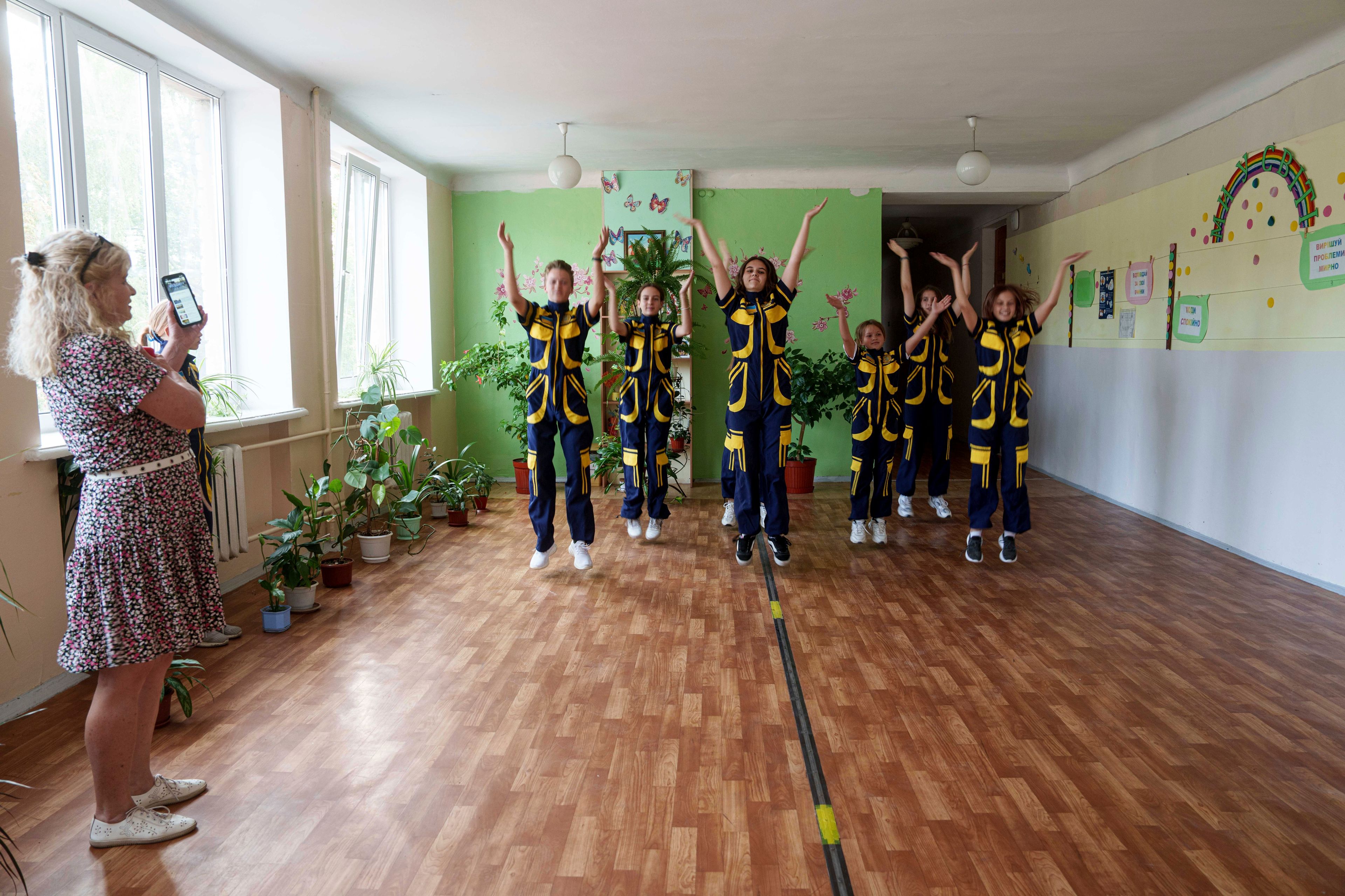 Children from School No. 88 rehearse a dance before the traditional back-to-school ceremony in Zaporizhzhia, Ukraine, Aug. 30, 2024. (AP Photo/Evgeniy Maloletka)