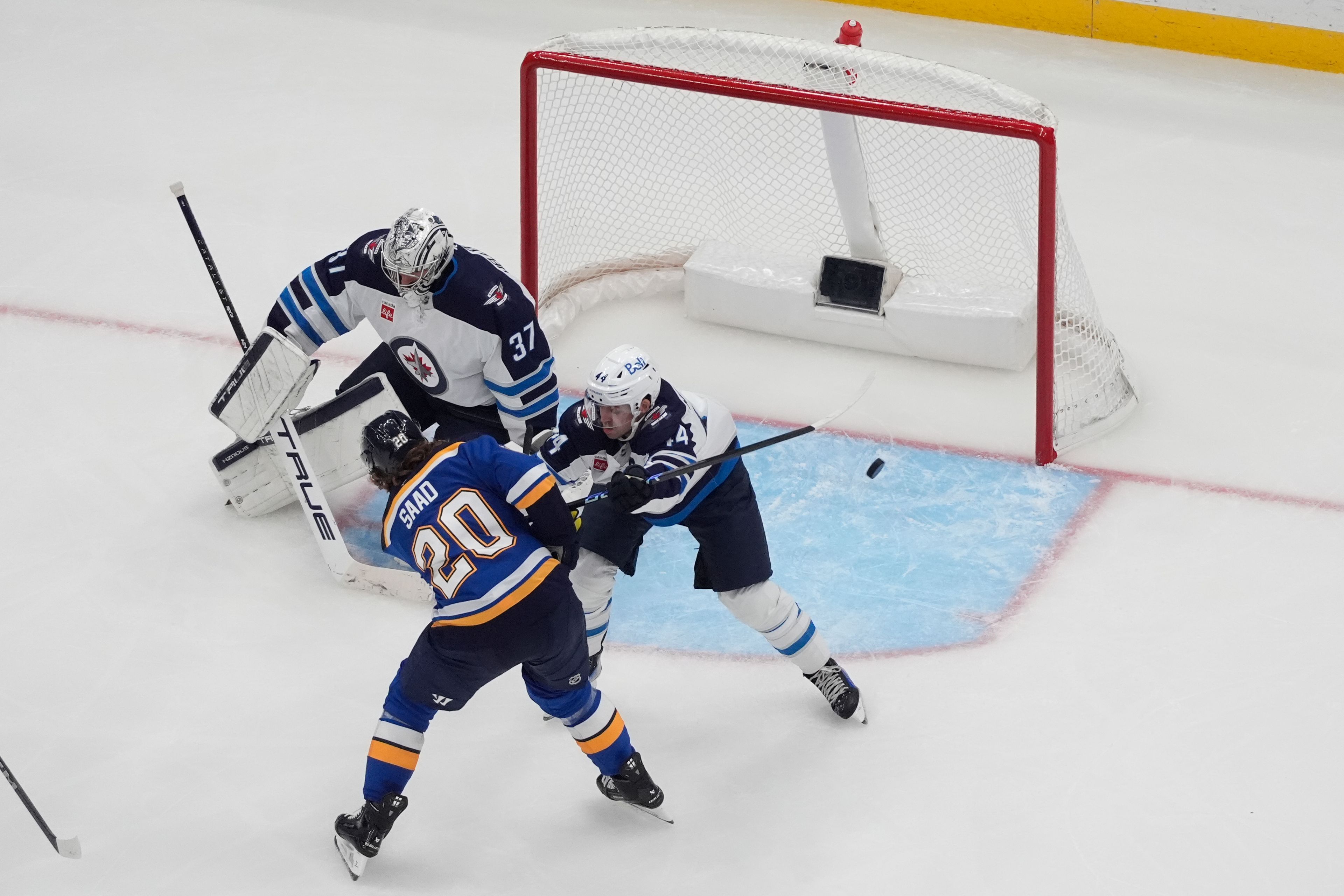  St. Louis Blues’ Brandon Saad scores past Winnipeg Jets goaltender Connor Hellebuyck and Josh Morrissey during the third period of an NHL game Tuesday in St. Louis.