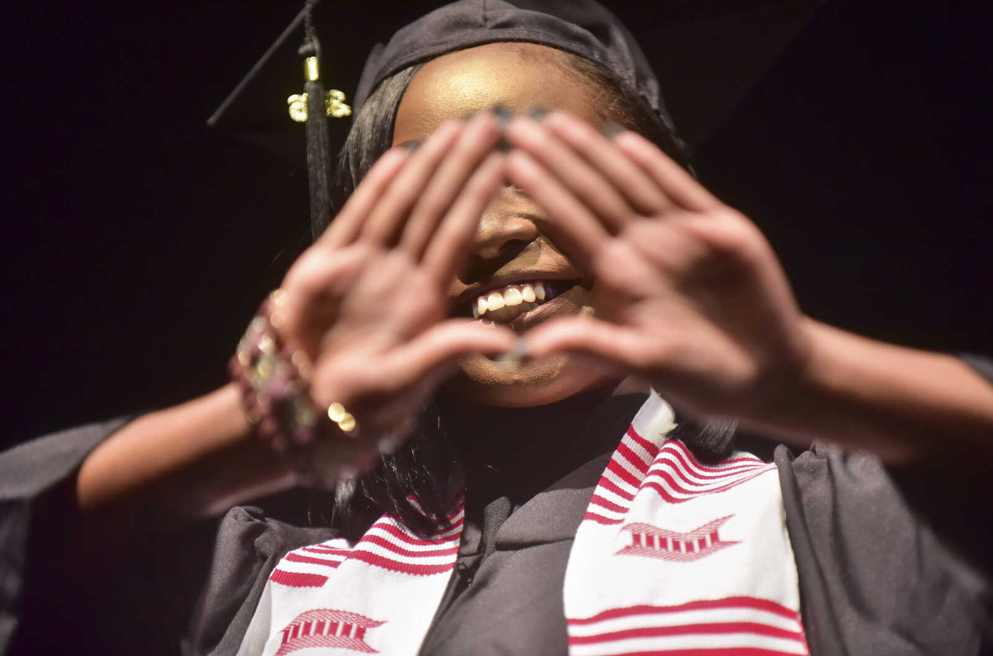 ANDREW J. WHITAKER ~ awhitaker@semissourian.com Santrelle Marion throws up the Delta Sigma Theta sign after walking on stage during Southeast Missouri State University graduation Saturday, Dec. 17, 2016 at the Show Me Center in Cape Girardeau.