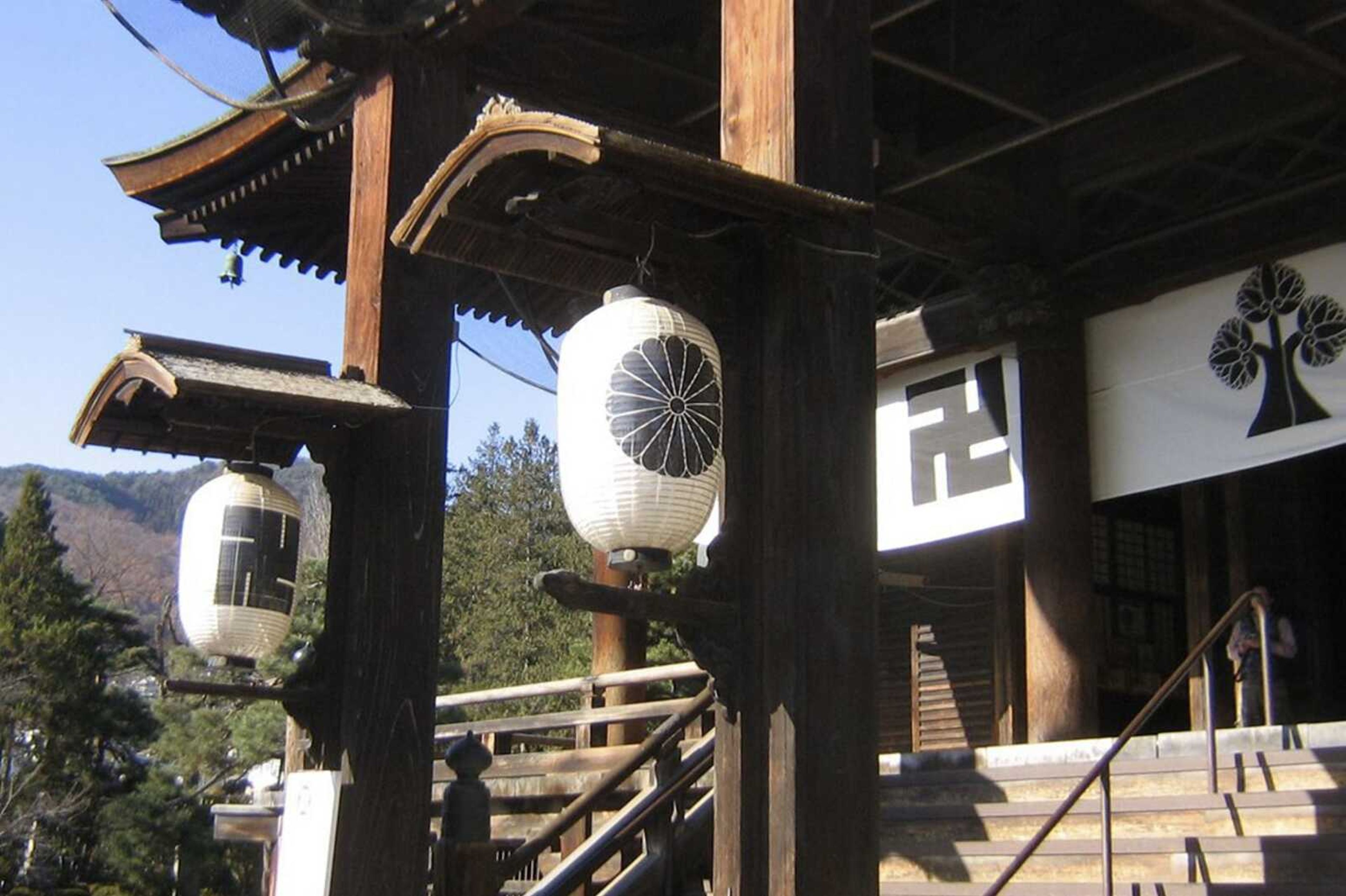 The Zenko-jo Buddhist temple in Nagano, Japan, founded in AD 642, Japan's first Buddhist temple. The swastika symbol is found in the temple's banners, paper lanterns, pillars, roof tiles and in the main shrine alongside the temple crest design of the hollyhock flower.