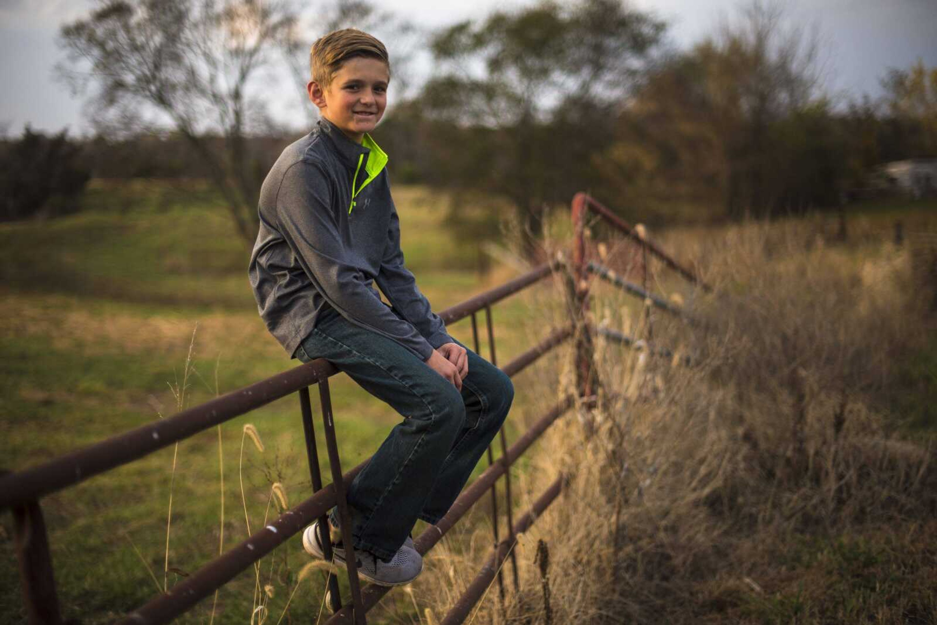 Connor Moore, 10, poses for a photo on his fence Nov. 2 in Perryville, Missouri.